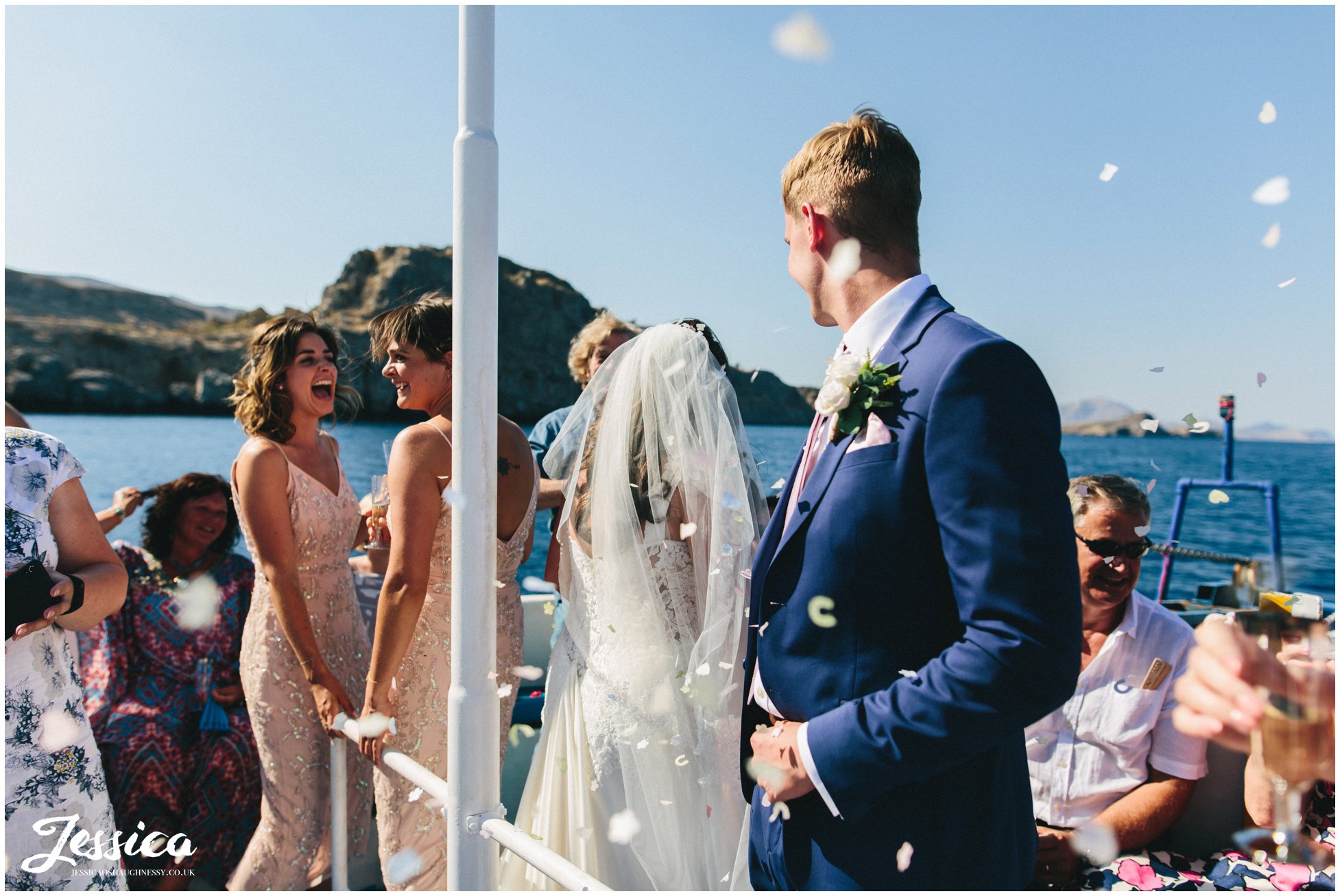 guests throw confetti on the new couple