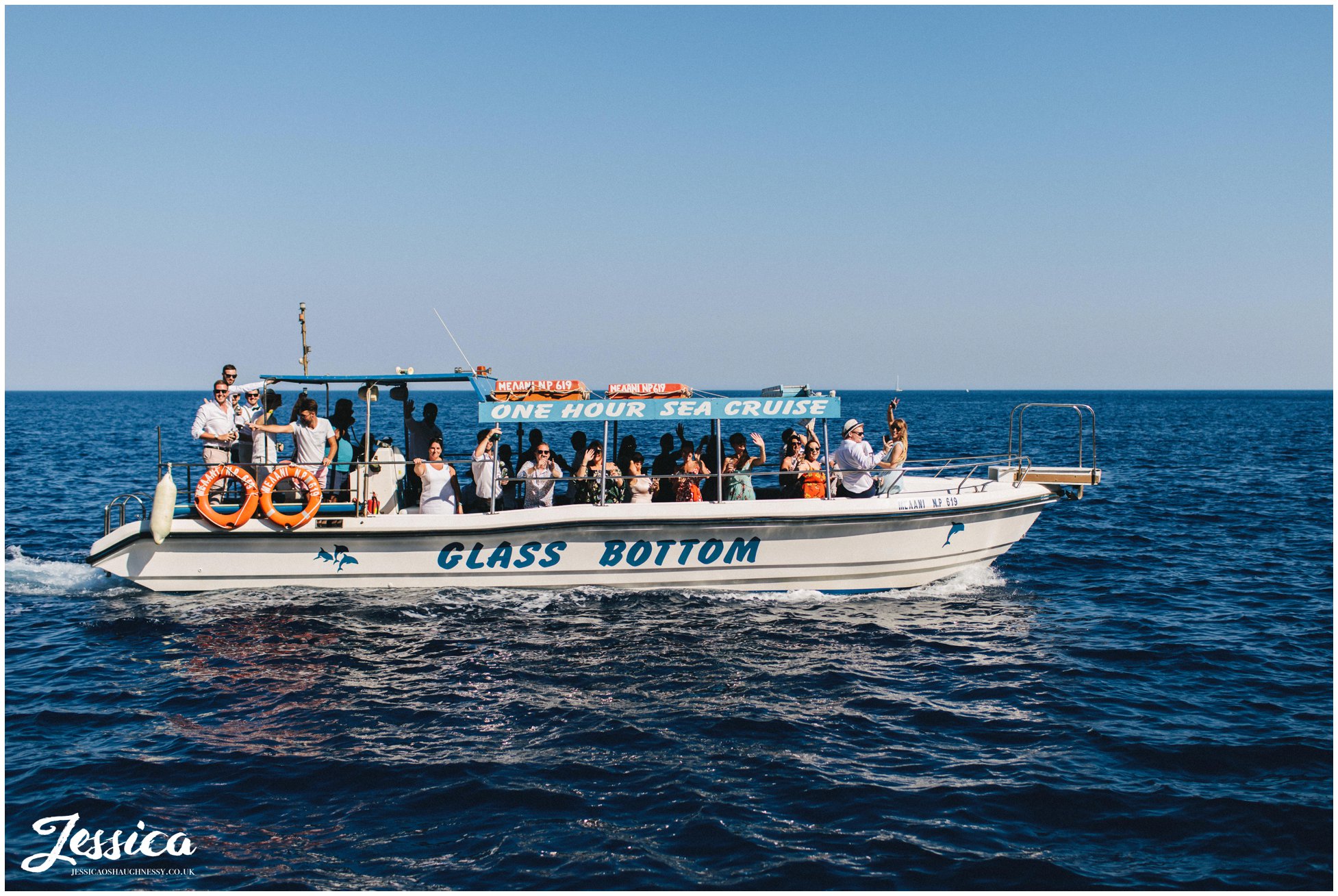 wedding guests cheer from the 2nd boat as it passes