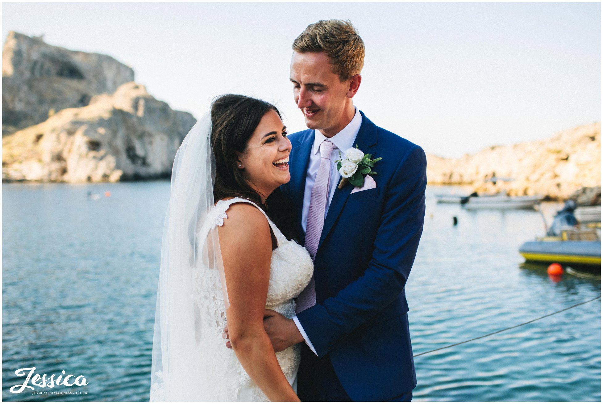 the couple laughing with each other on the jetty at st paul's bay