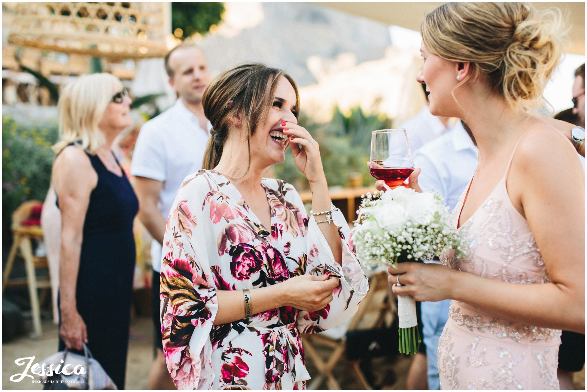 wedding guest laughs at Tambakio Restaurant wedding reception