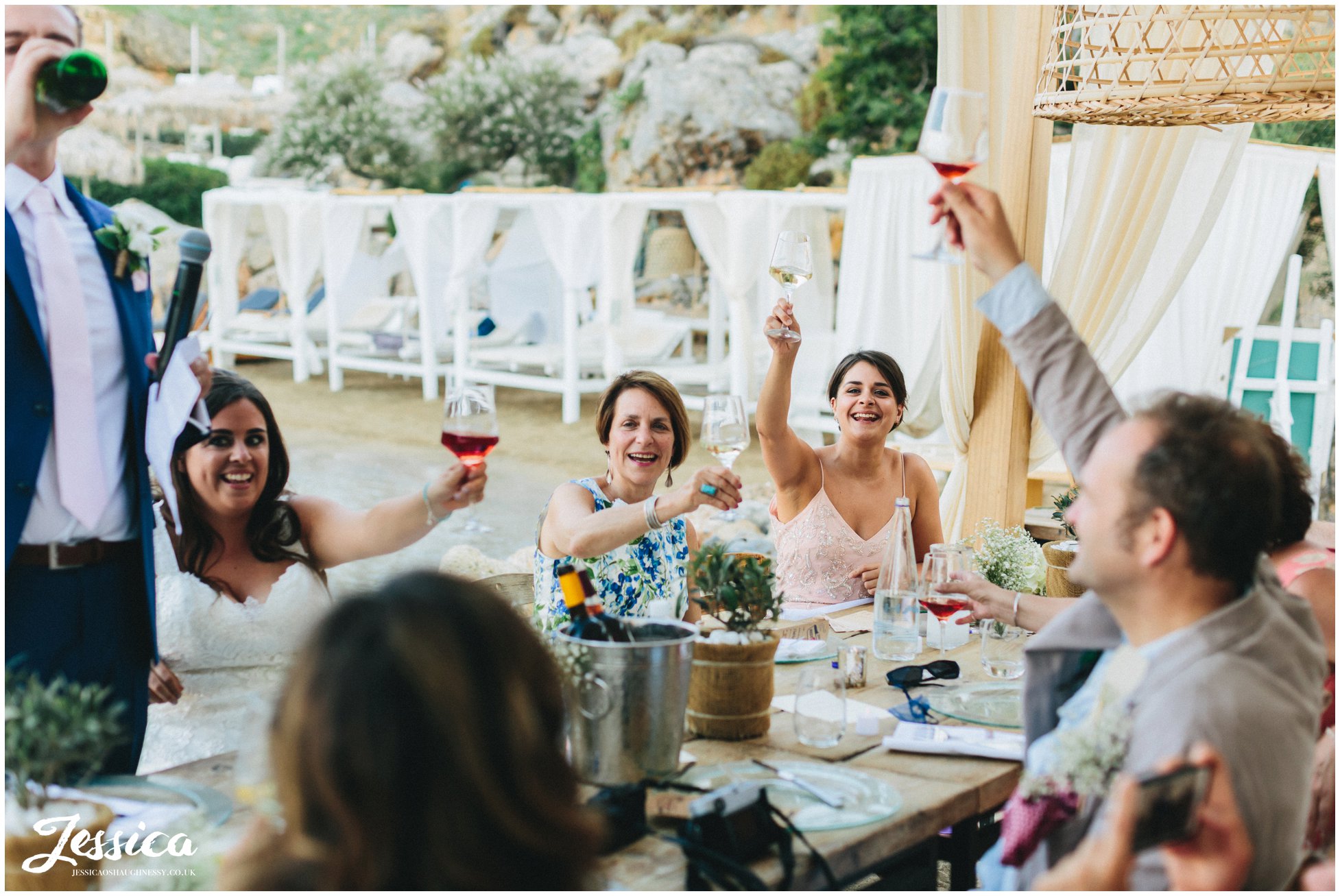 the brides family cheer as the groom finishes his speech