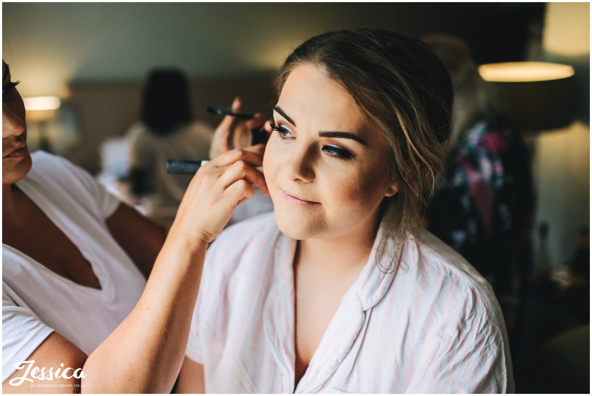 bride gets her make up done for the ceremony at mottram hall