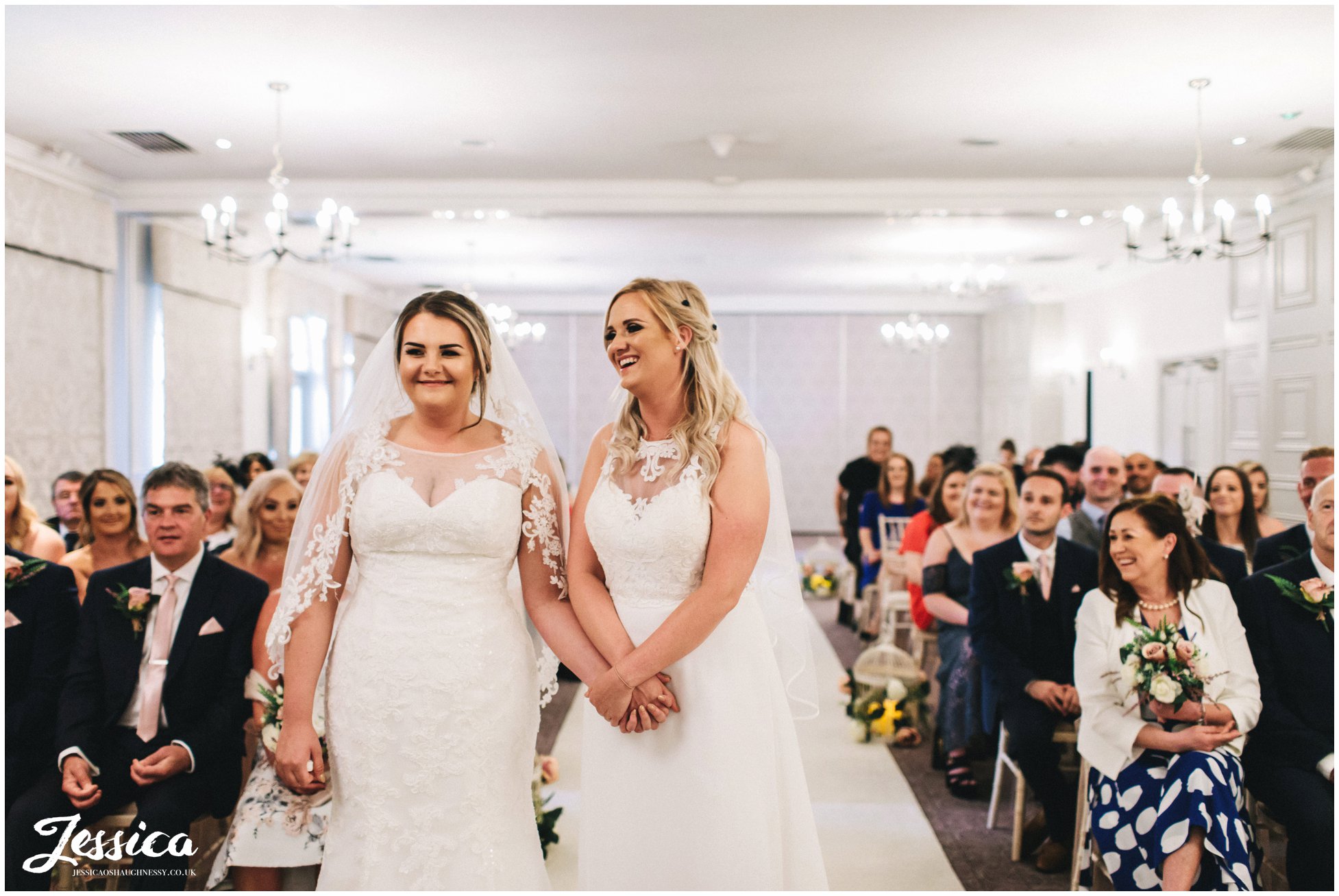 the brides laugh during their wedding ceremony in cheshire