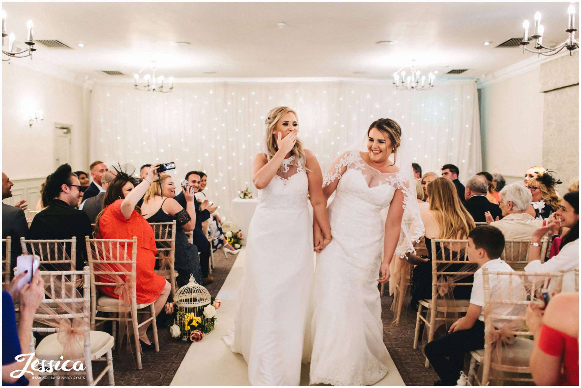 the brides walk down the aisle as wife & wife