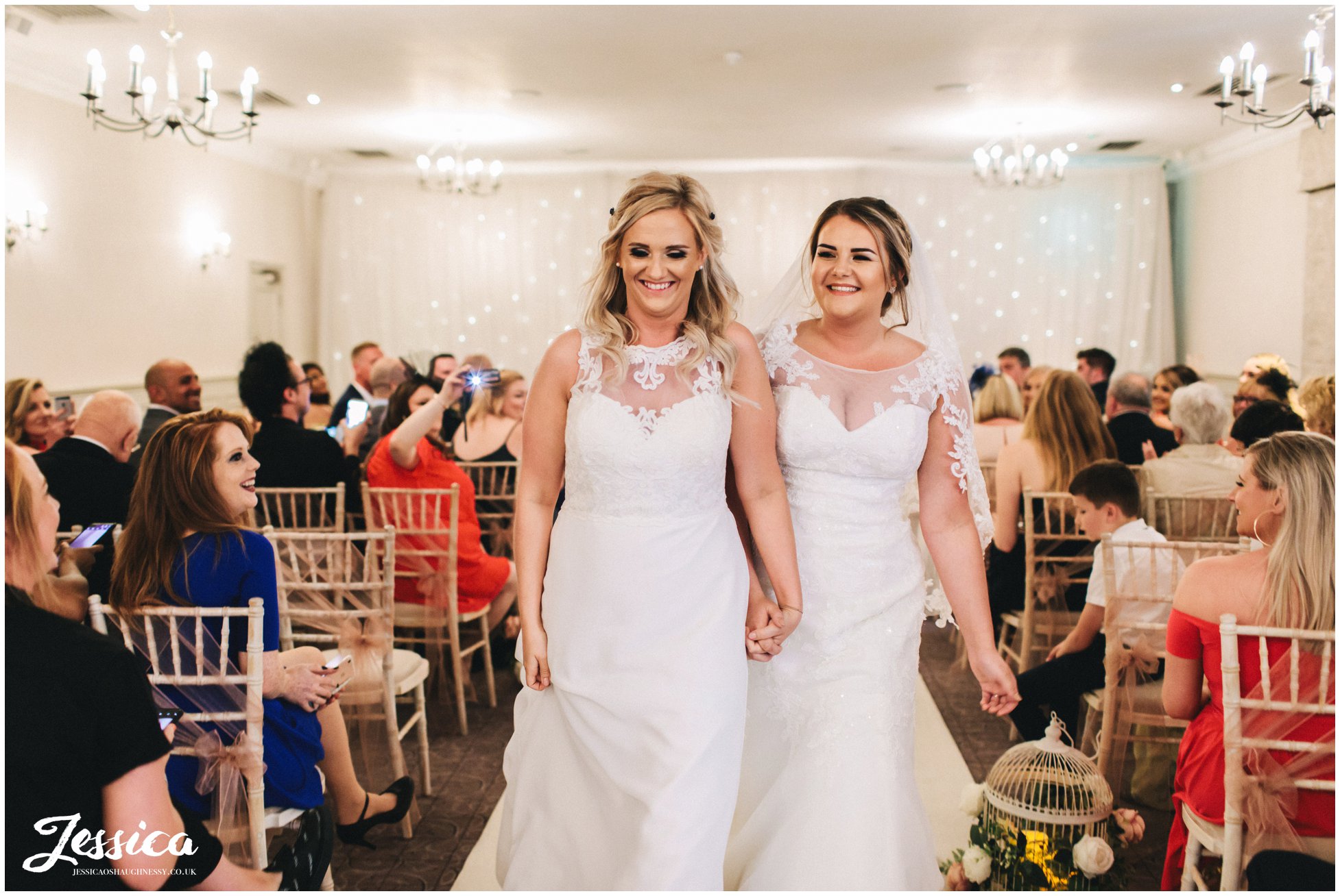 the brides laugh as they walk down the aisle as a married couple