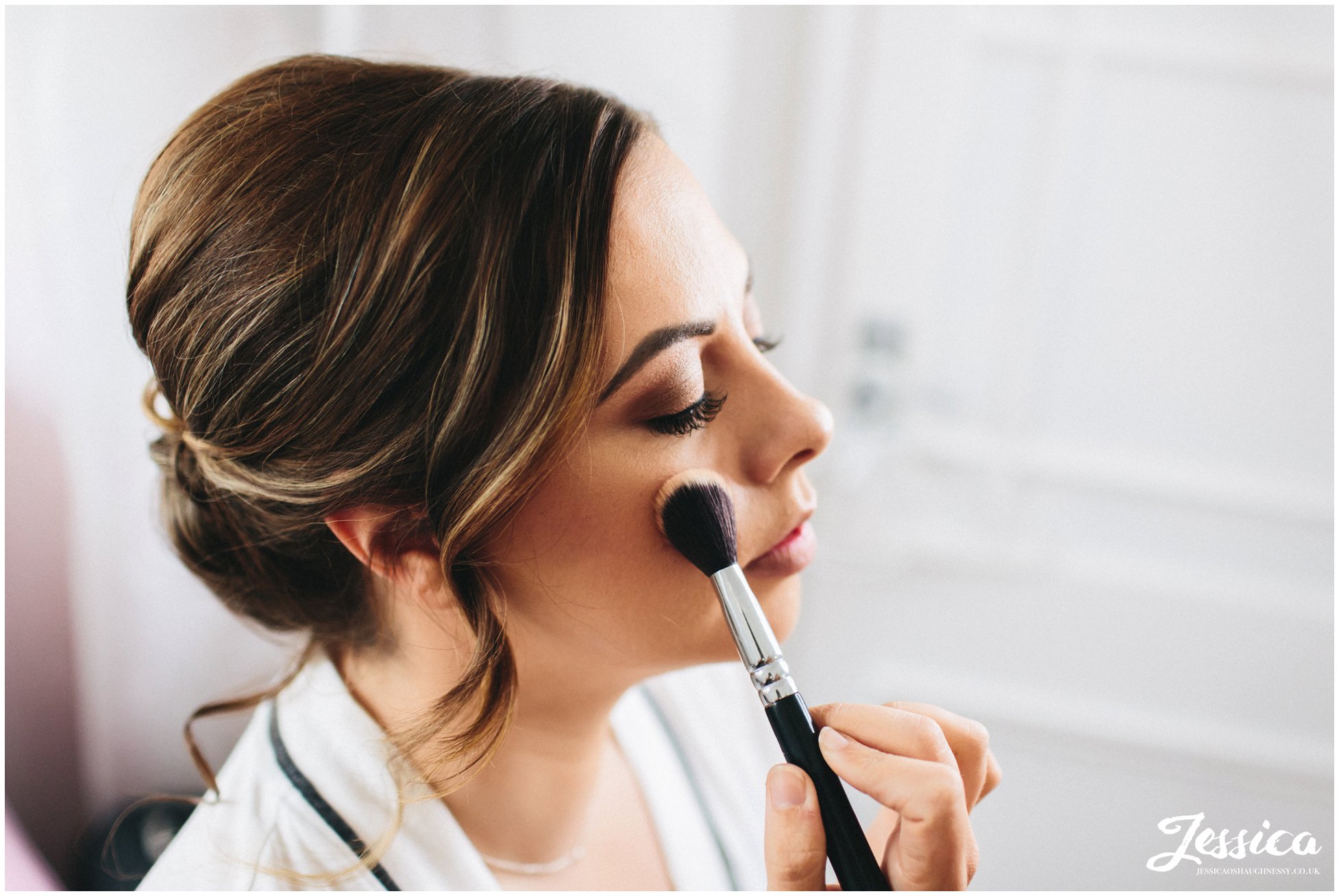 the bride gets her make-up done in the belle epoque hotel room