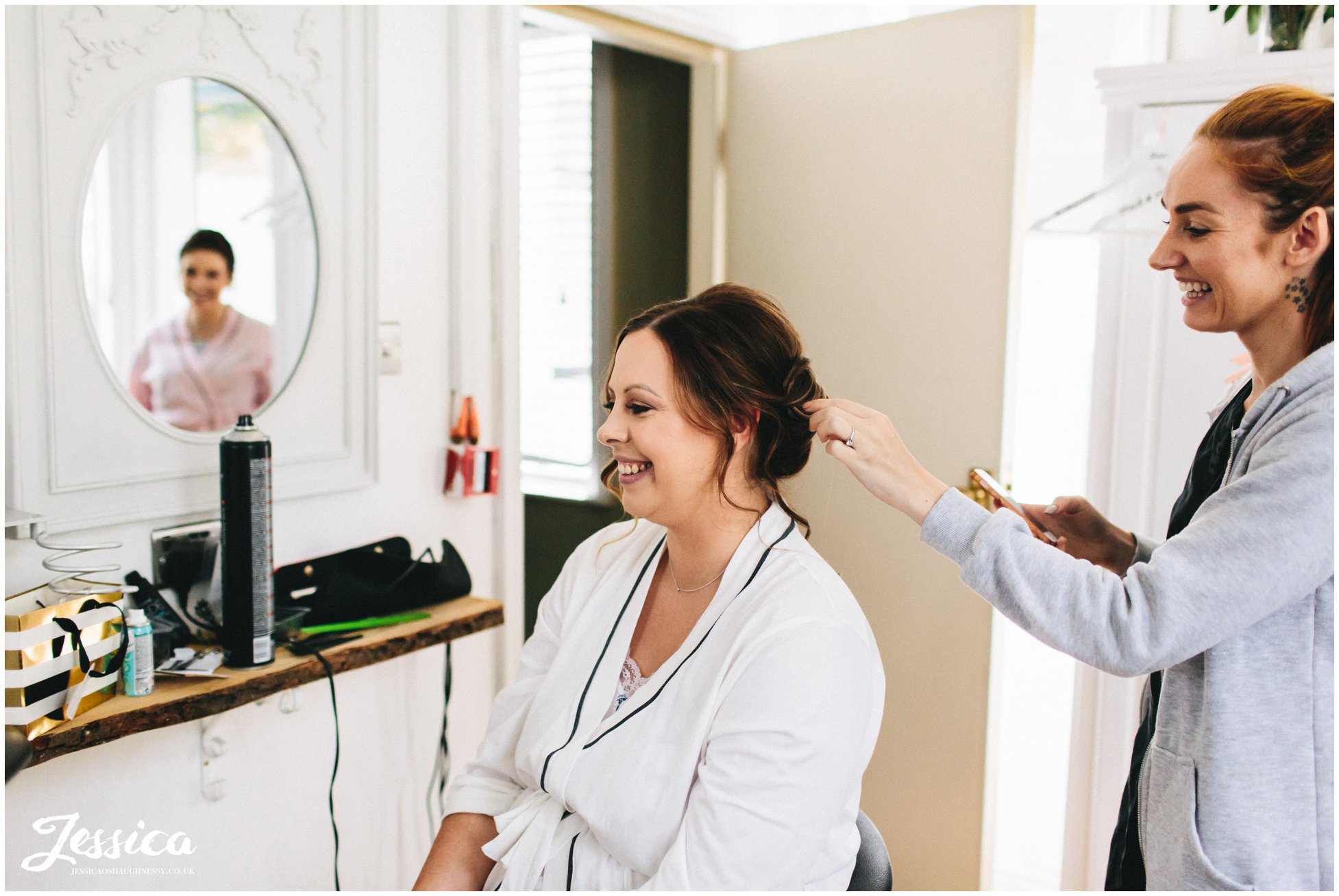 bride laughs as she prepares for her wedding day in knutsford