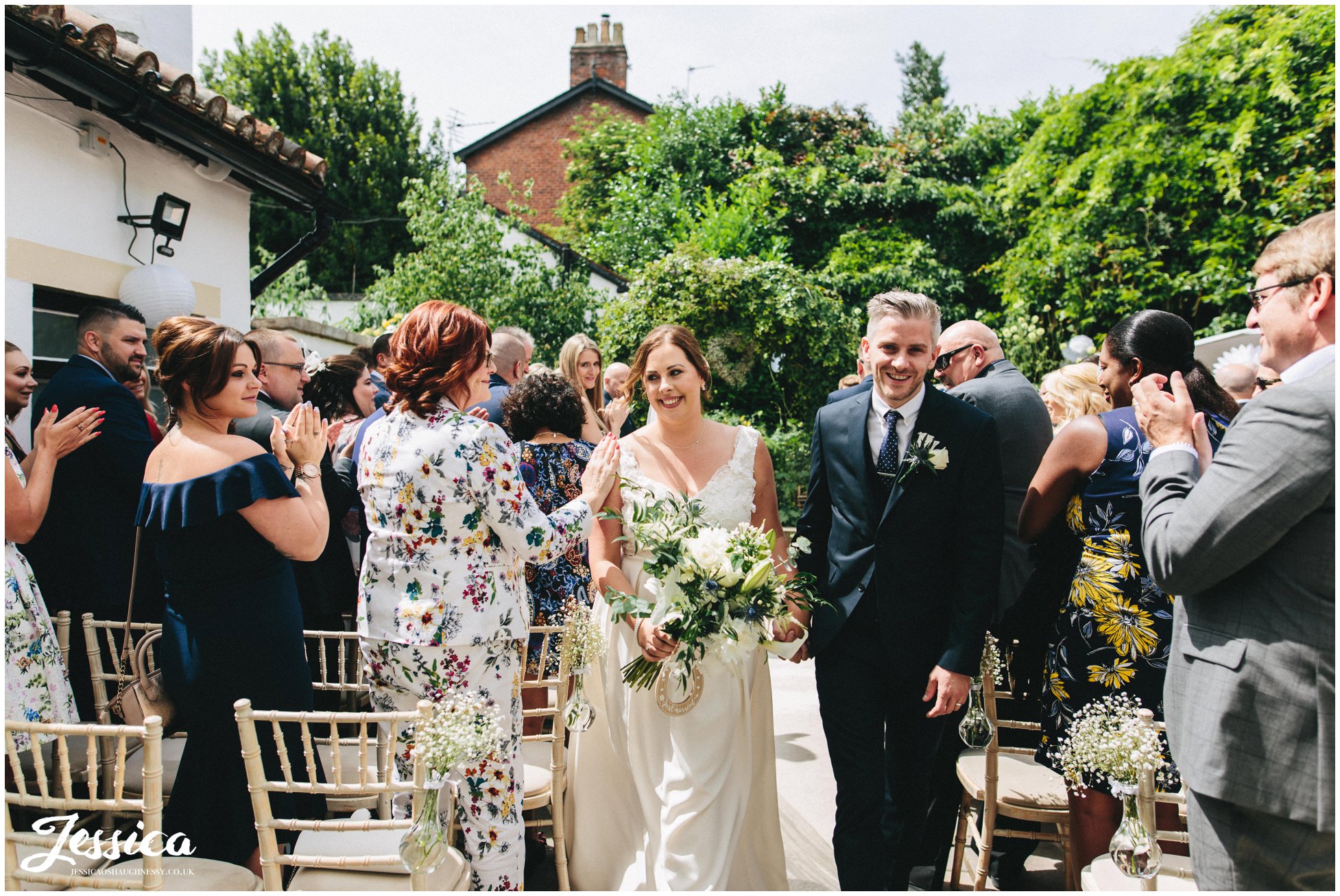 the newly wed's walk down the aisle as husband and wife