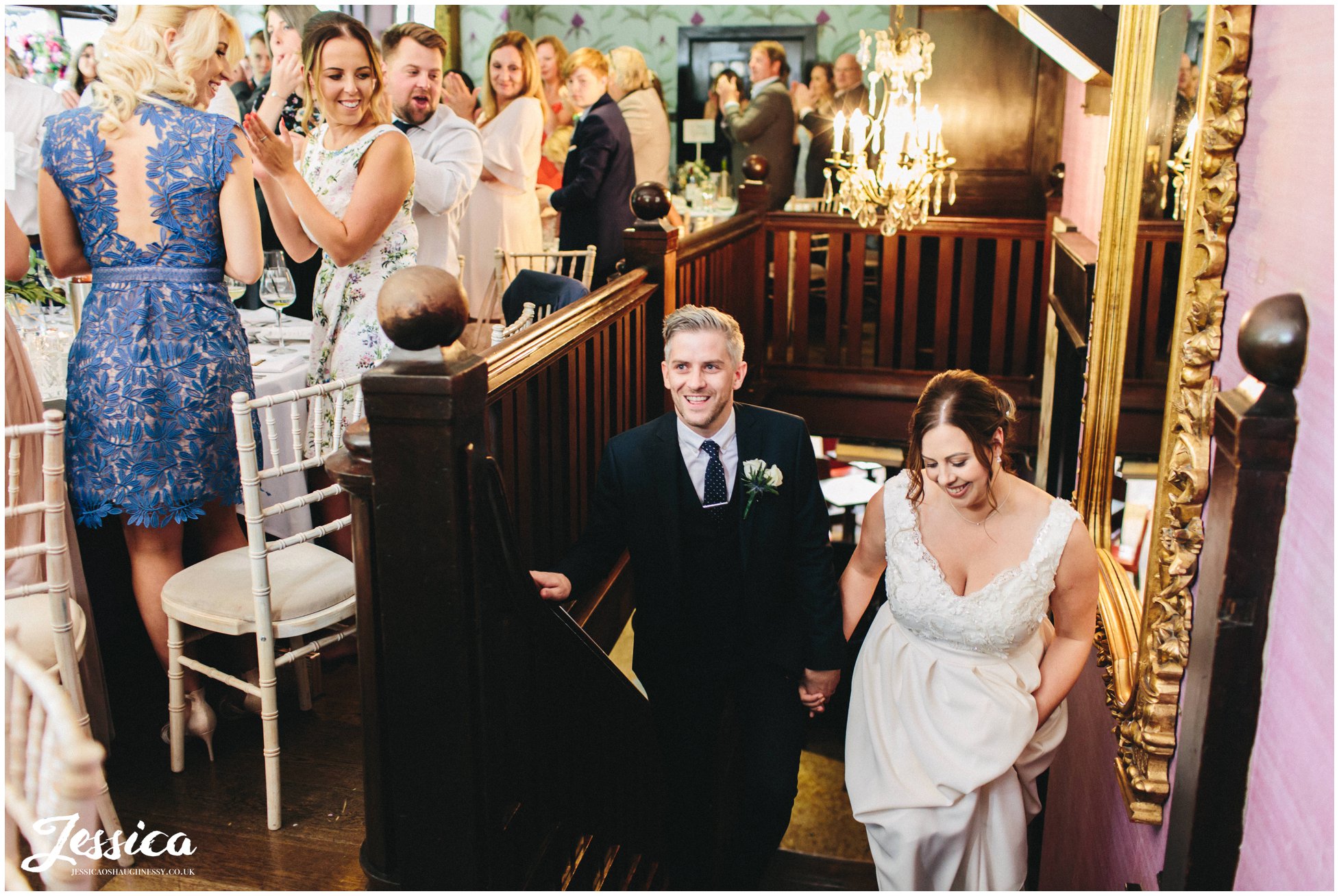 the newly wed's are announced into the garden room