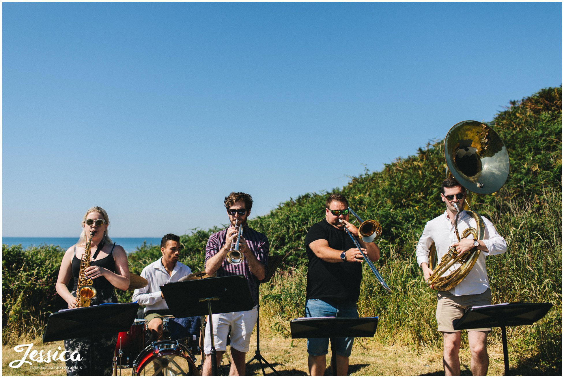 a brass band plays to the wedding party at bach wen farm in north wales