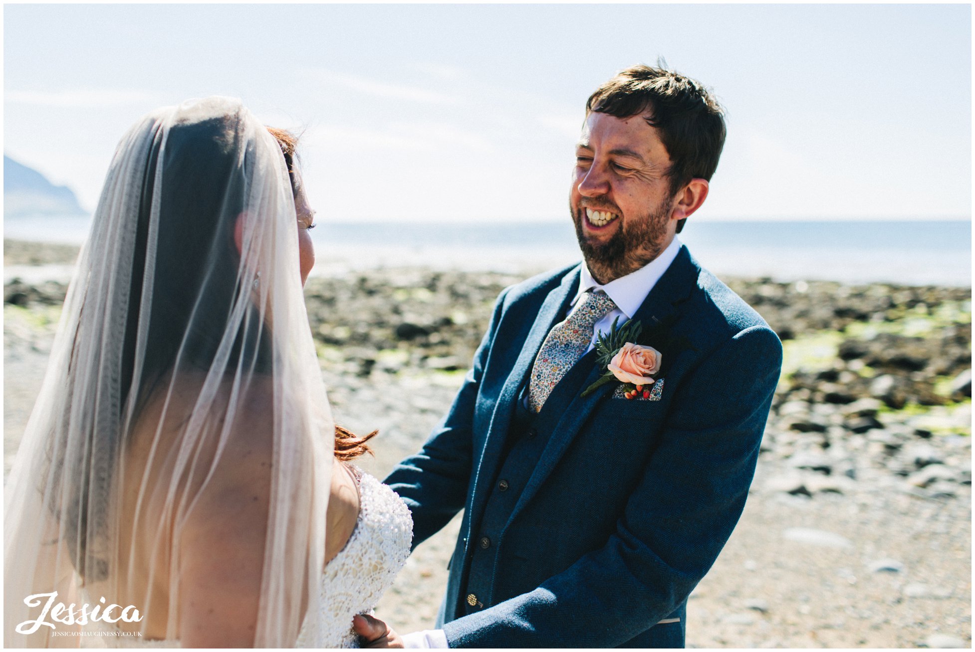 the groom laughs with his bride on their north wales wedding day