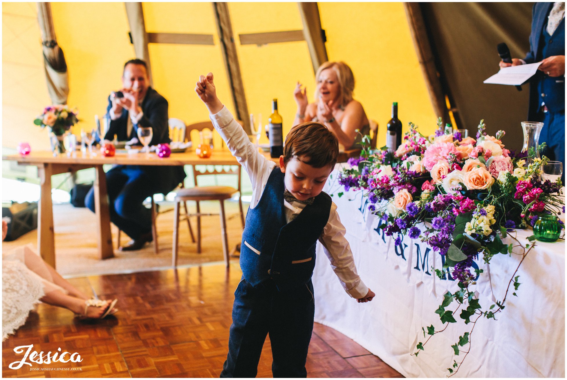 the bride & groom's son poses during the speeches