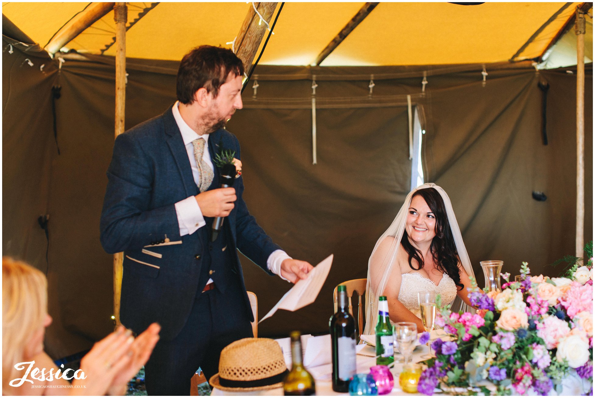 the bride laughs as the groom makes his speech