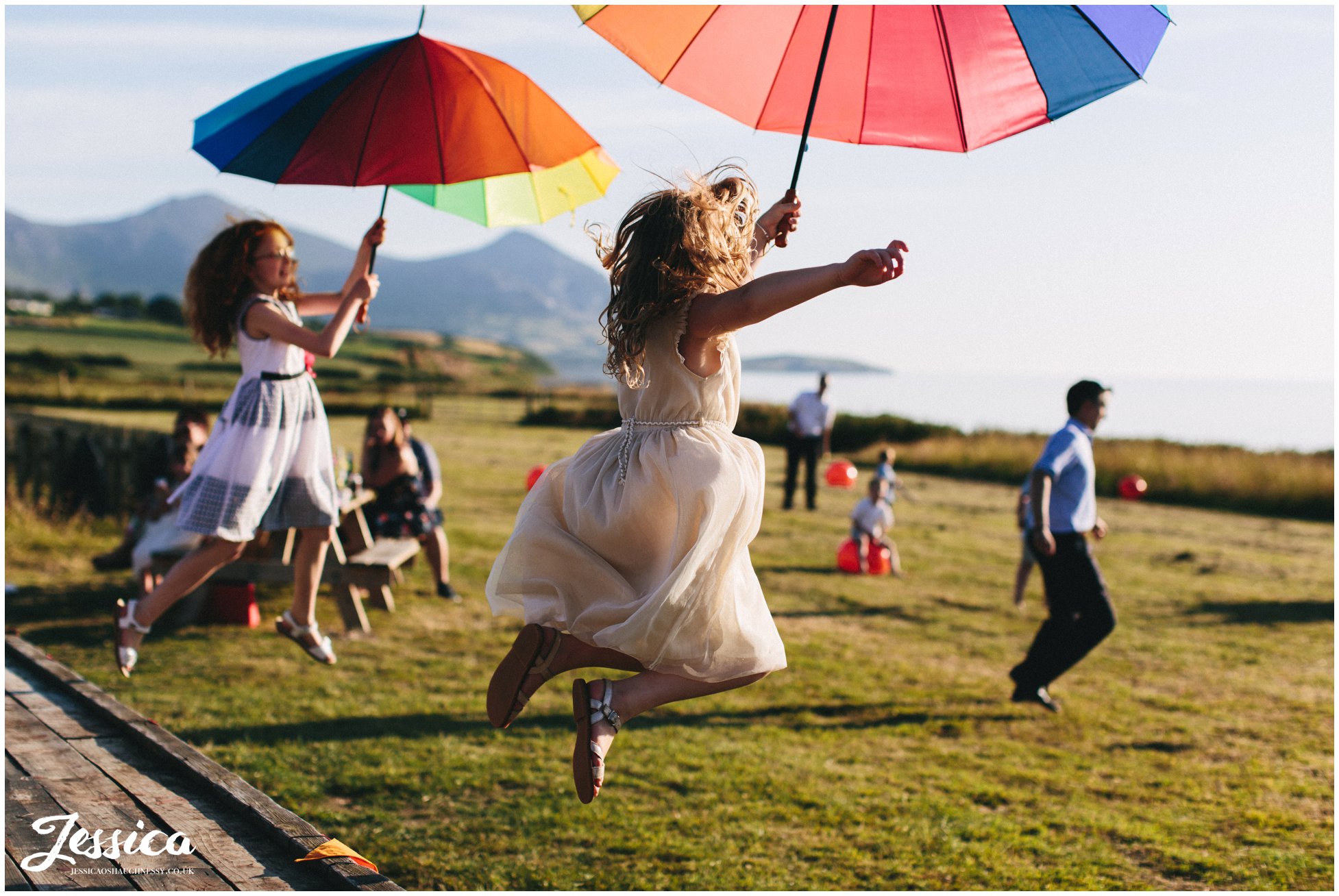 children jump off trailer with rainbow balloons