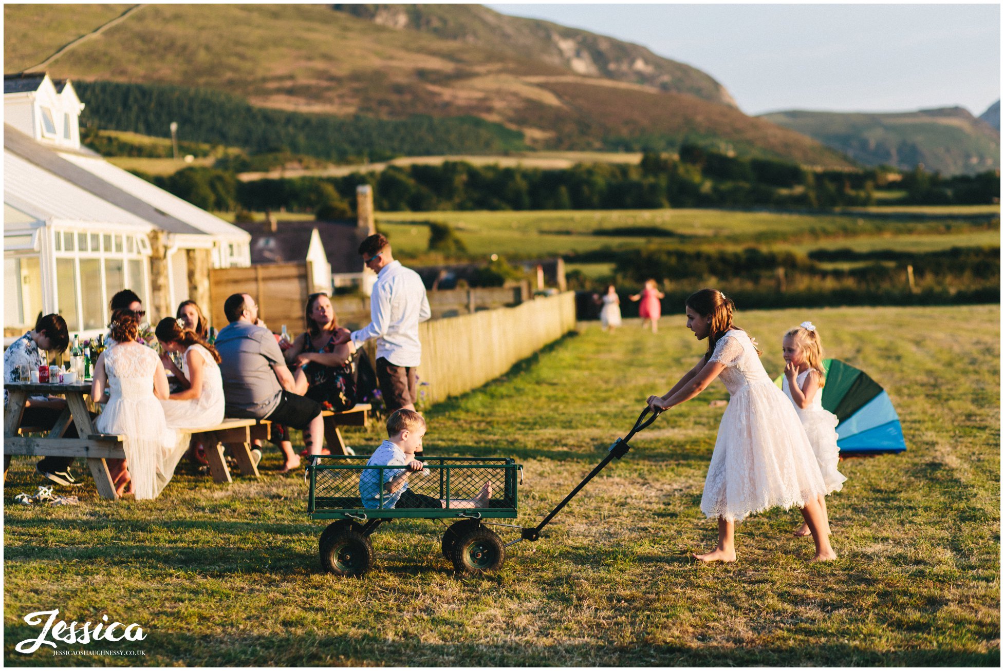 bridesmaid drags young child around in a trailer