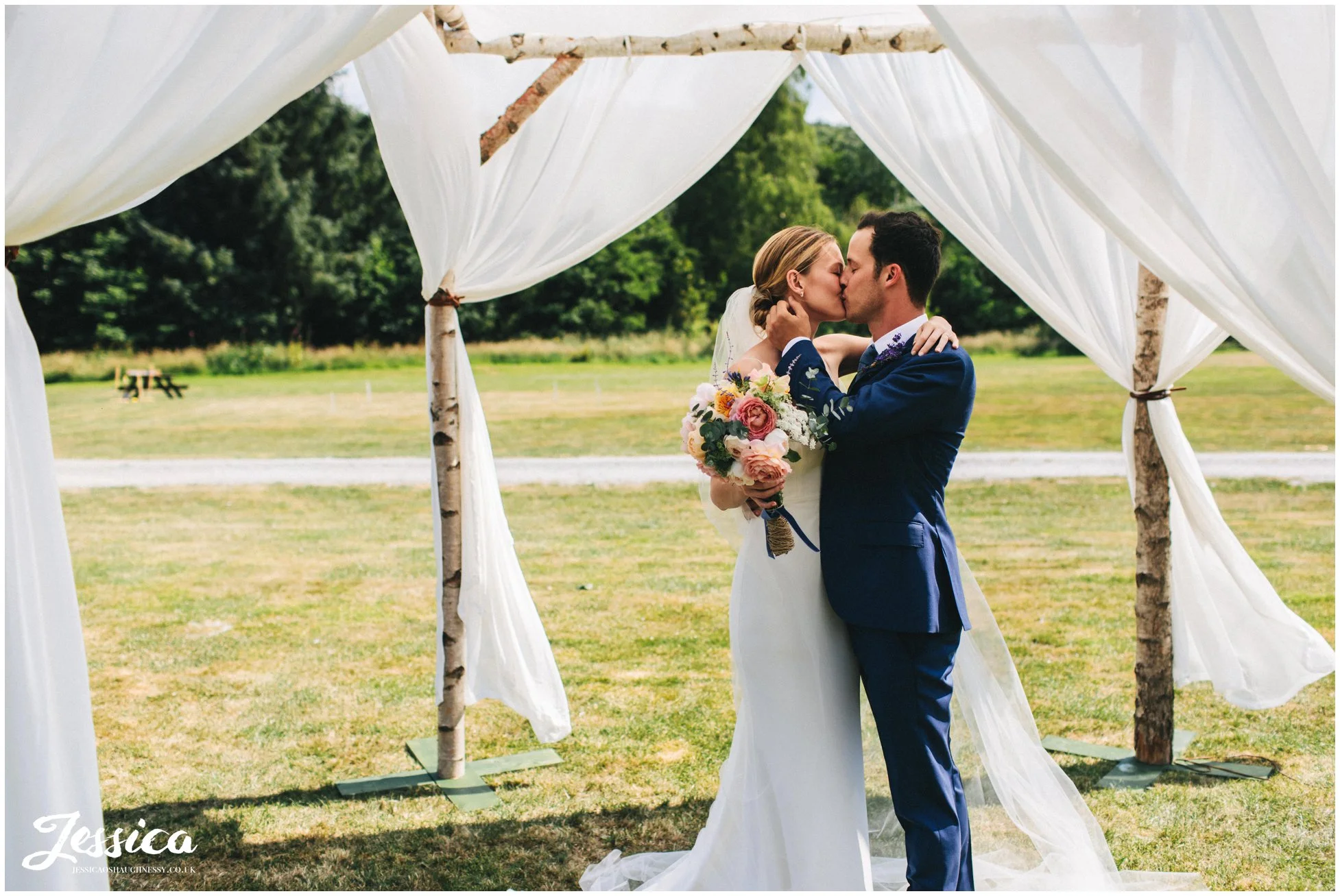 the bride & groom to be kiss under the chuppah