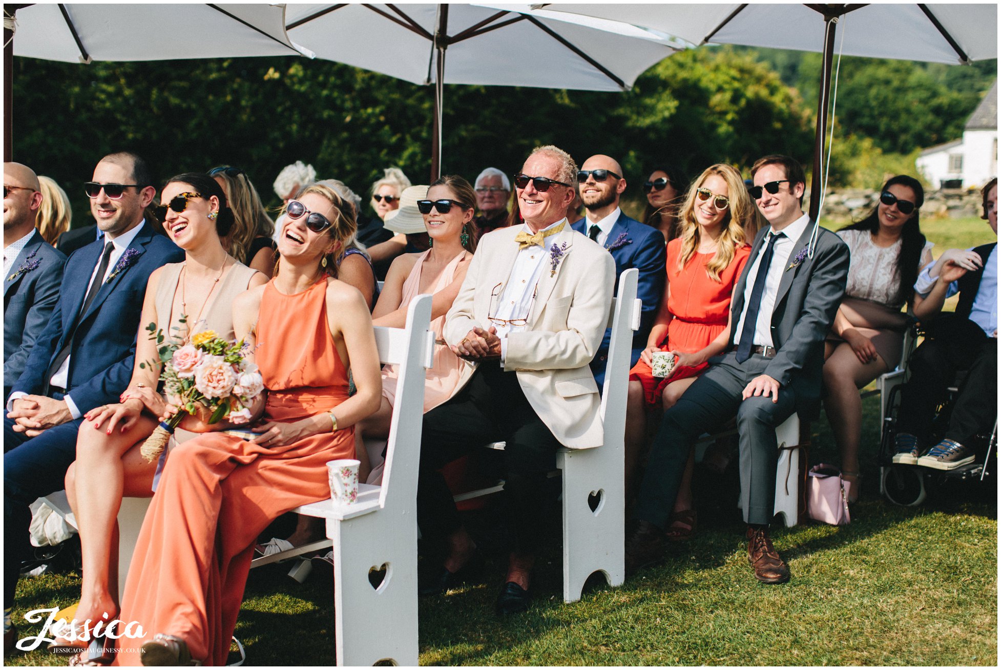 wedding guests laugh during funny moment