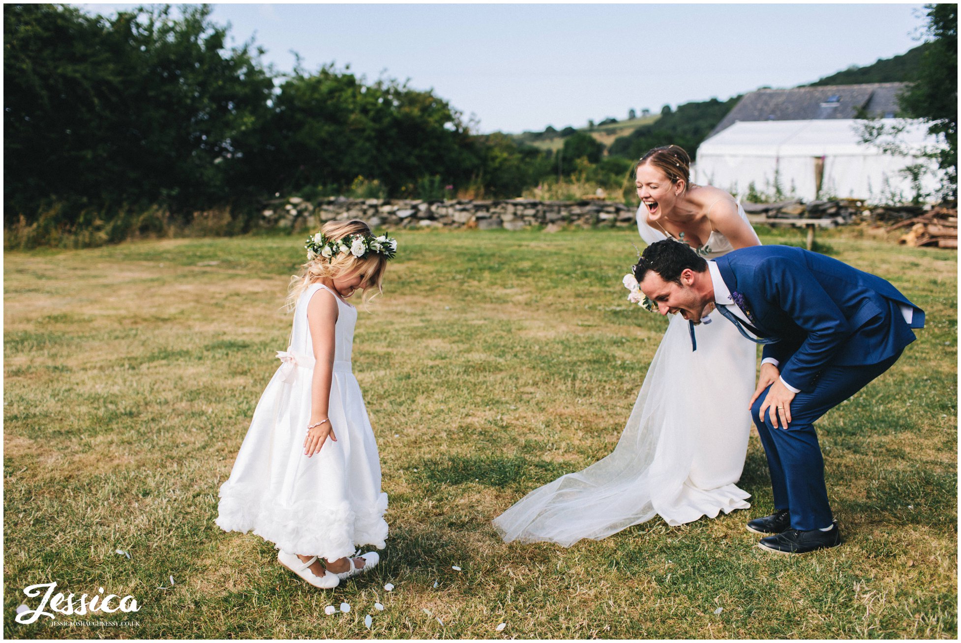 flower girl throws confetti over the couple