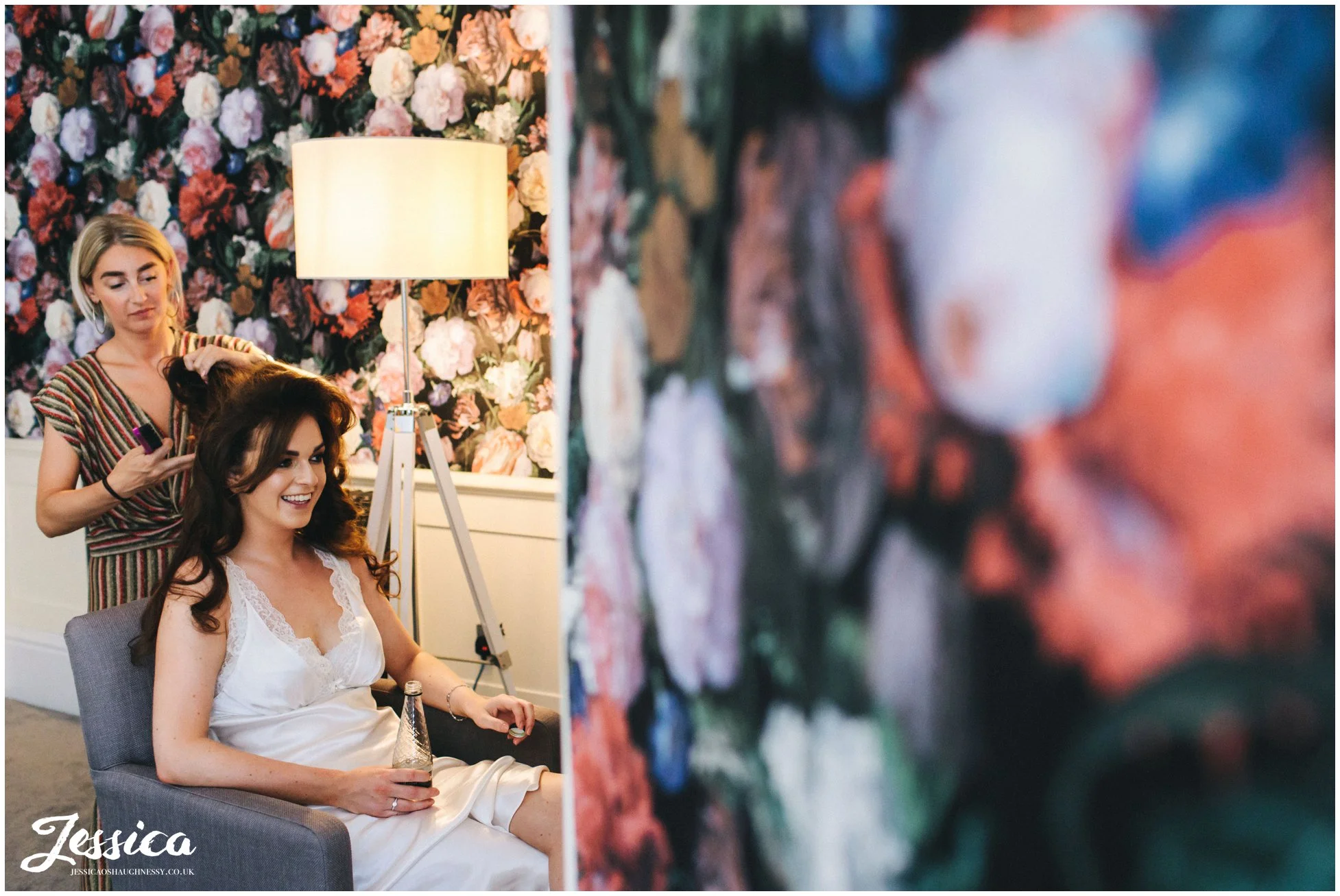 the bride gets her hair done ready for the wedding ceremony