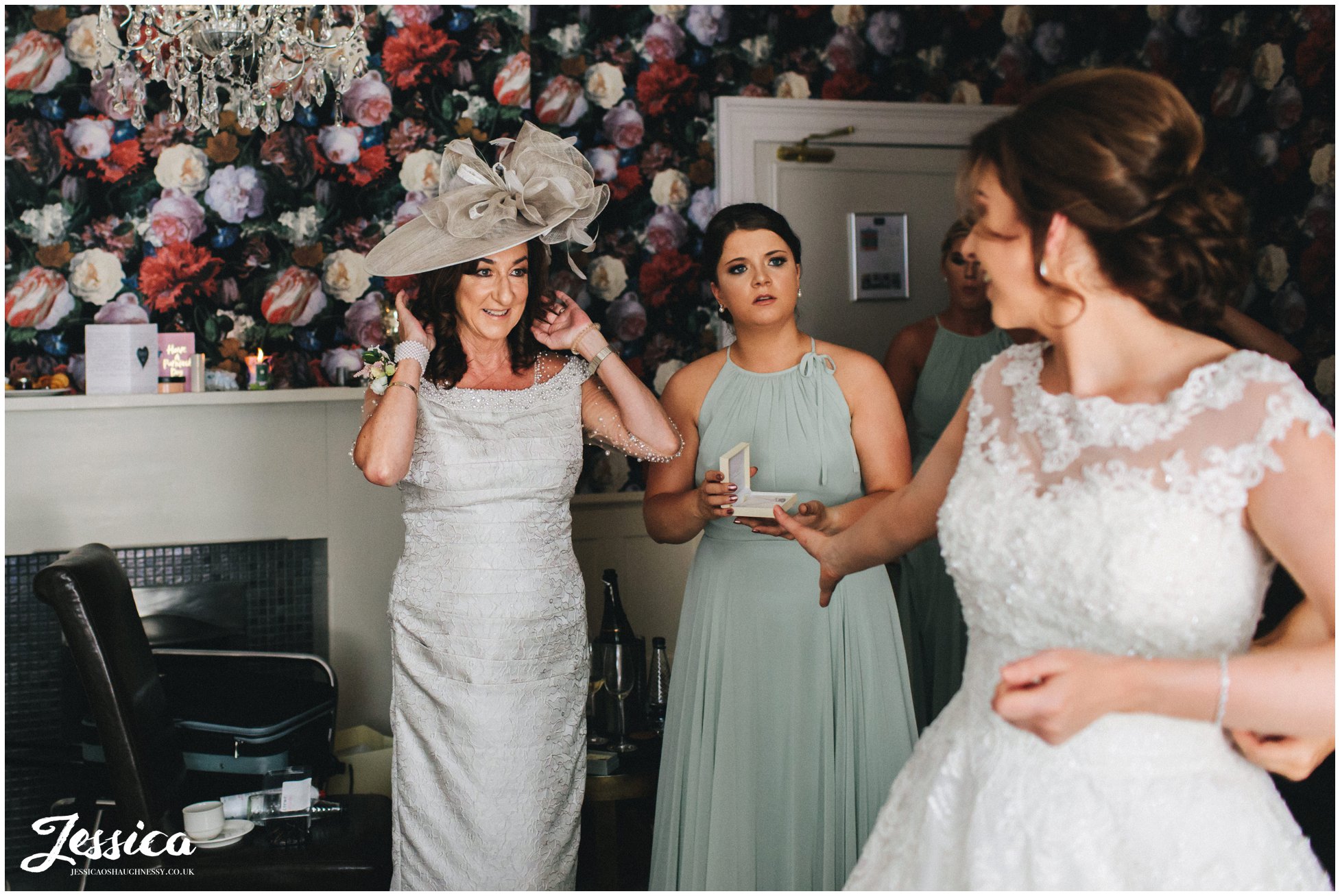 mother of the bride admires her daughter dressed for her wedding