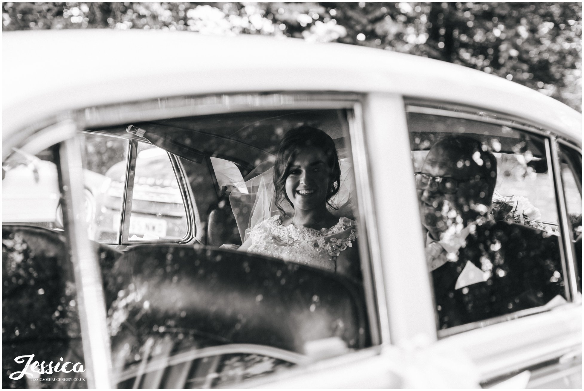 the bride arrives at the lancashire church in the vintage wedding car