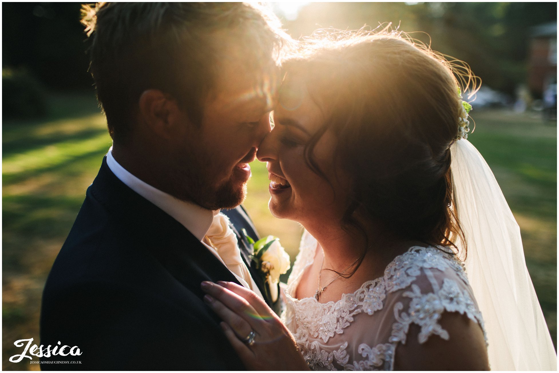 close up of the bride & groom laughing in the golden hour