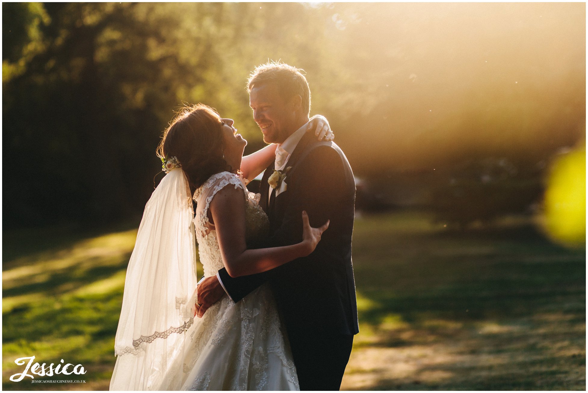 couple embrace in the evening sun outside their north west wedding venue, bartle hall