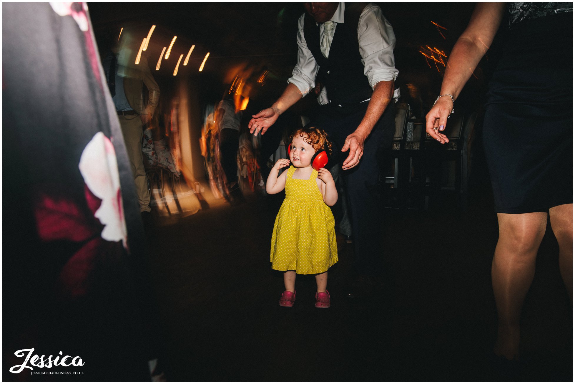 flower girls wears headphones on the dancefloor