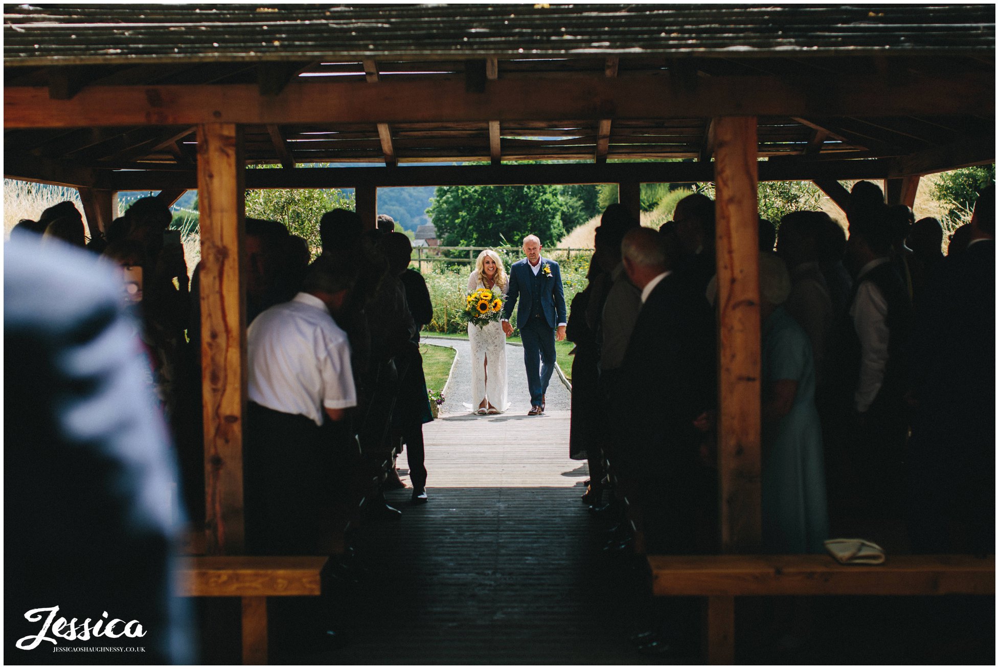 the bride walks down the aisle with her father