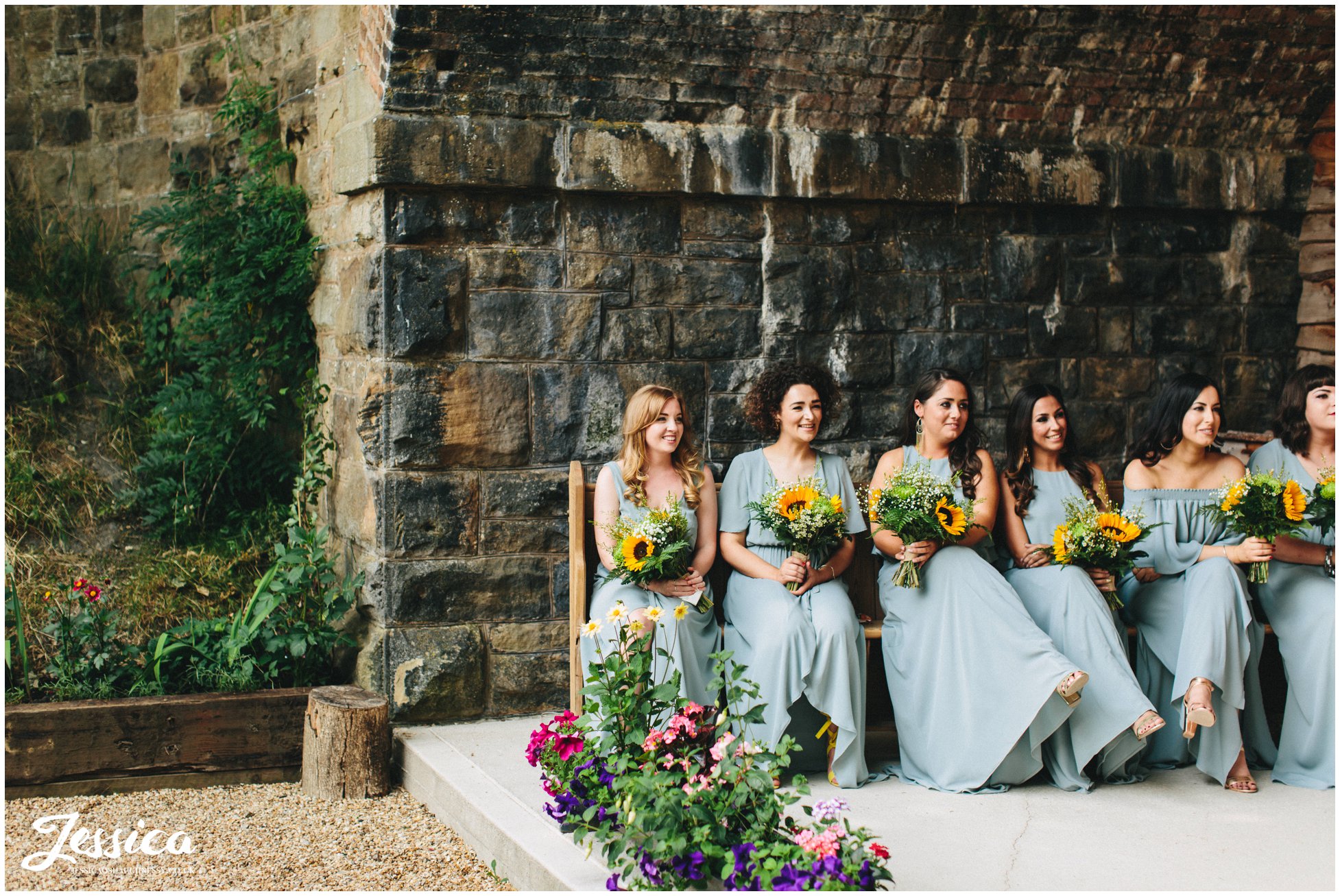 bridesmaids smile during the north wales wedding ceremony