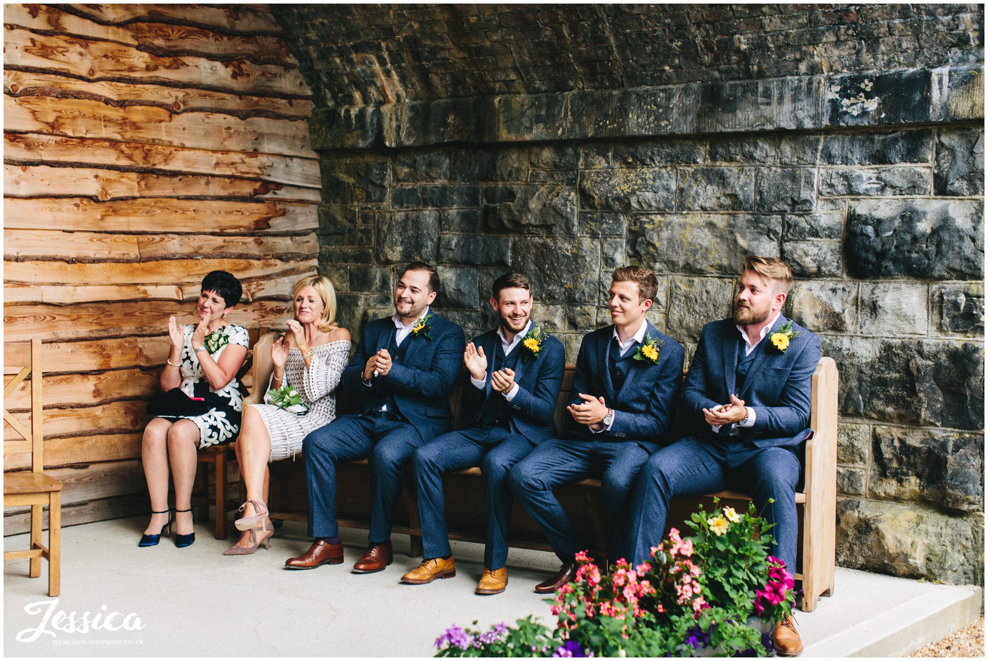 wedding party clap as the couple are announced husband and wife