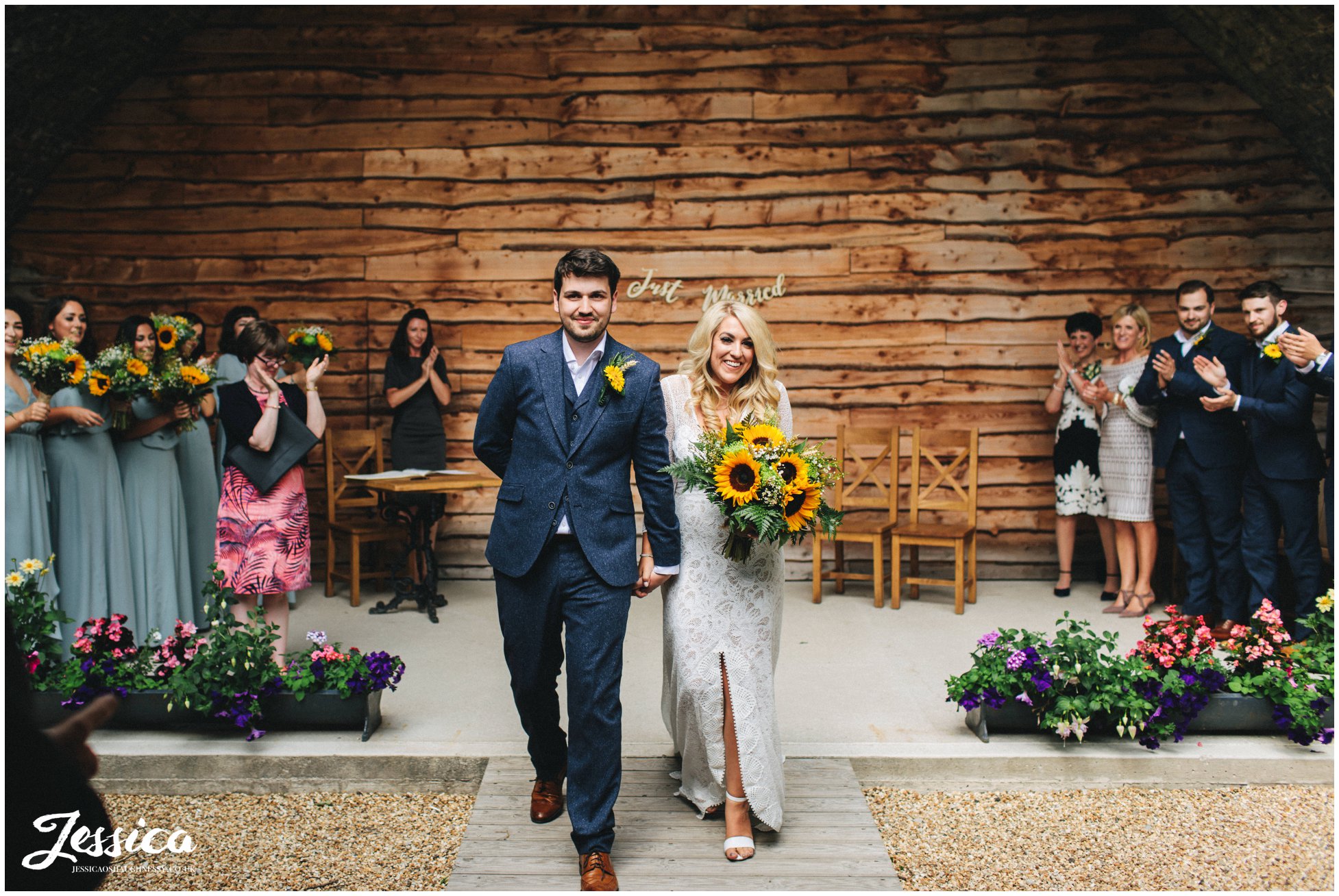 newly wed's walk back down the aisle together