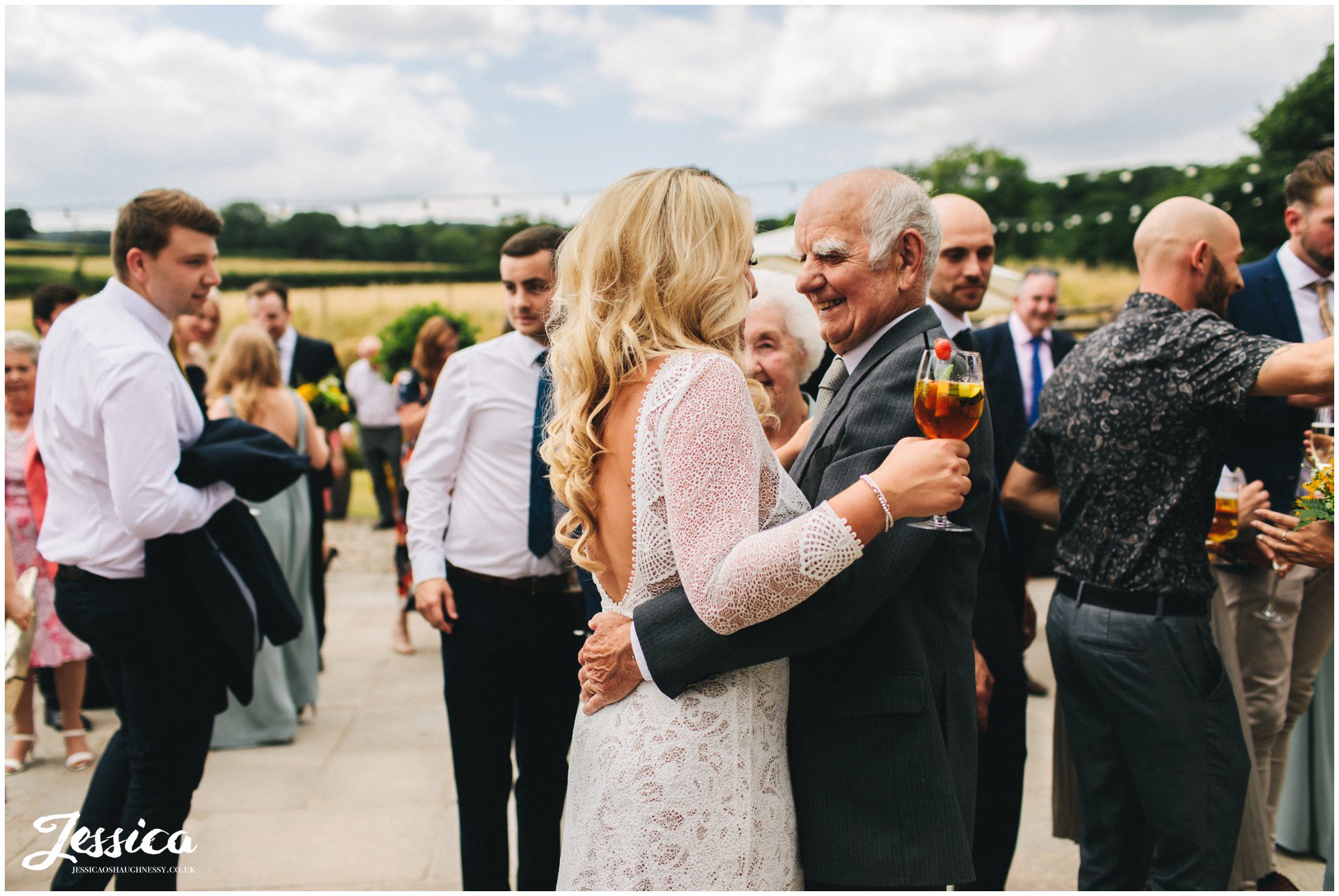 the bride hugs her grandfather at tower hill barns