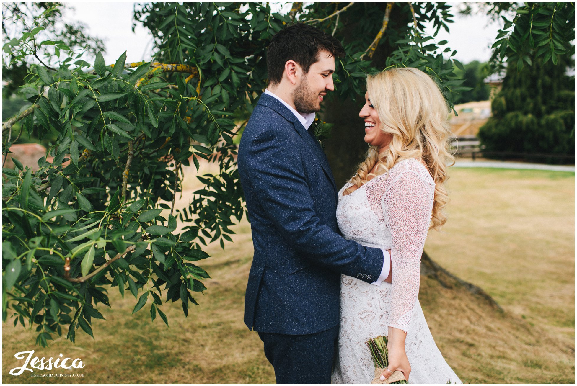 newly wed's laugh together at their tower hill barns wedding