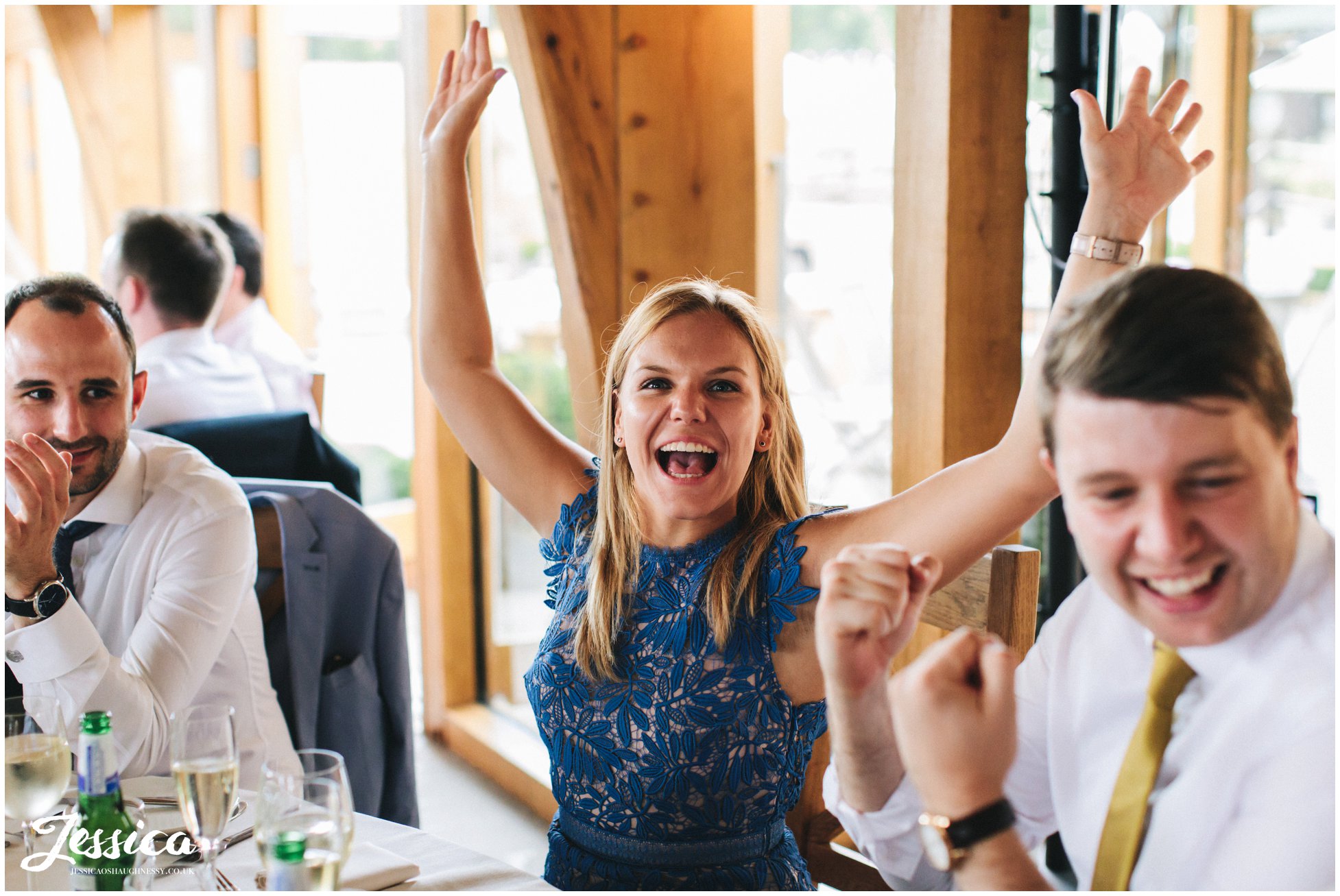 guest cheers with arms in the air