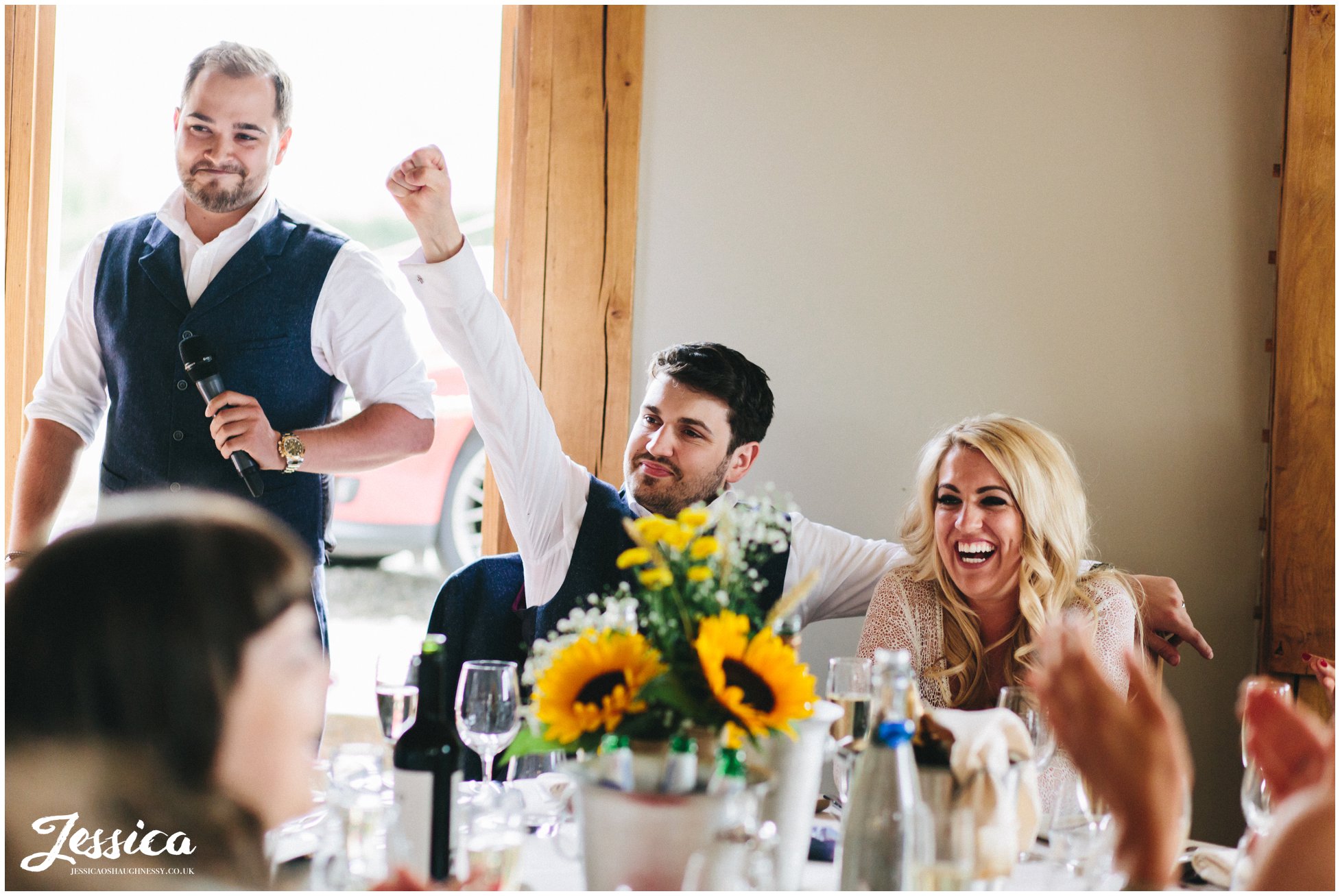 groom cheers during the best man's speech