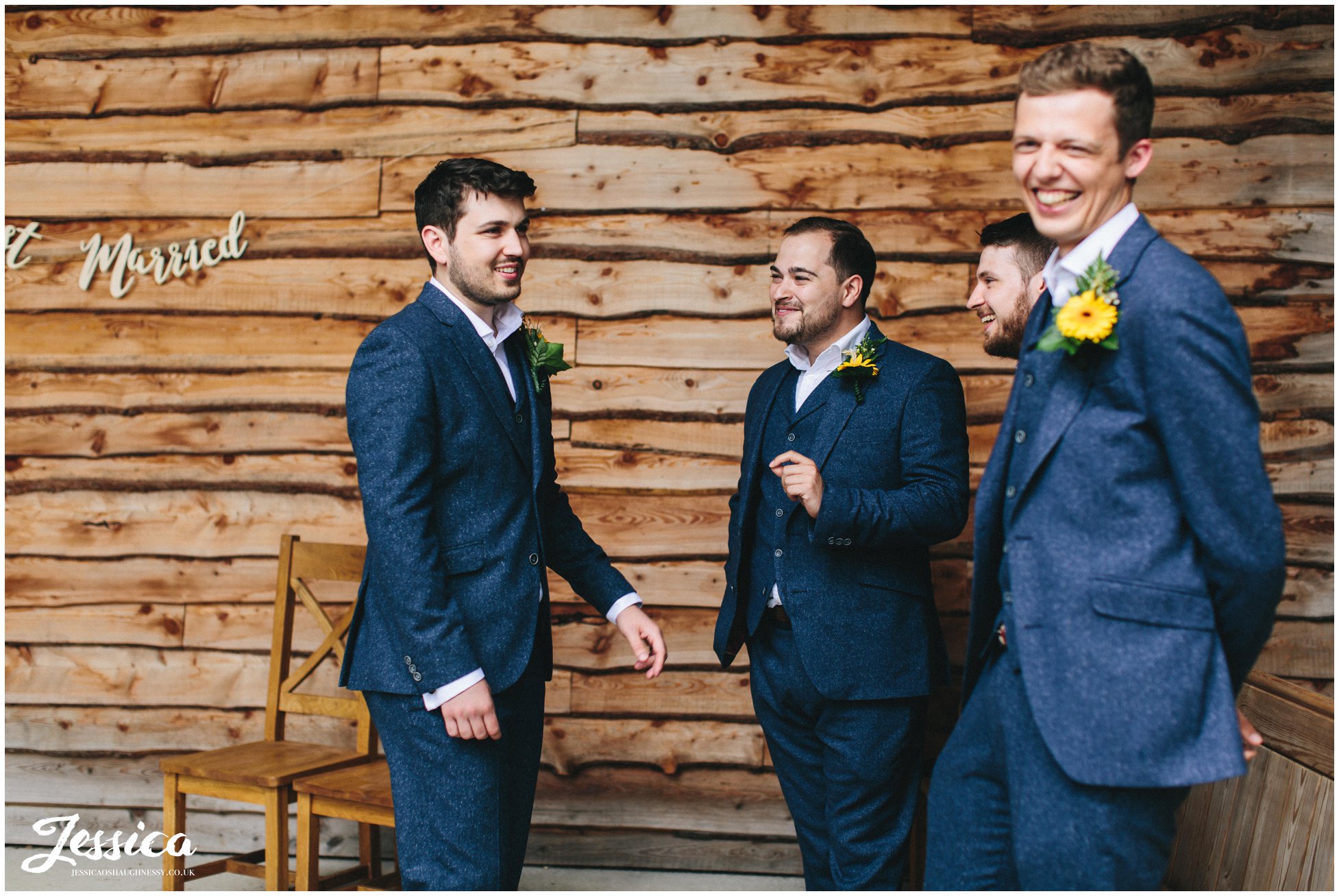 the groom laughs with his groomsmen before the ceremony at tower hill barns