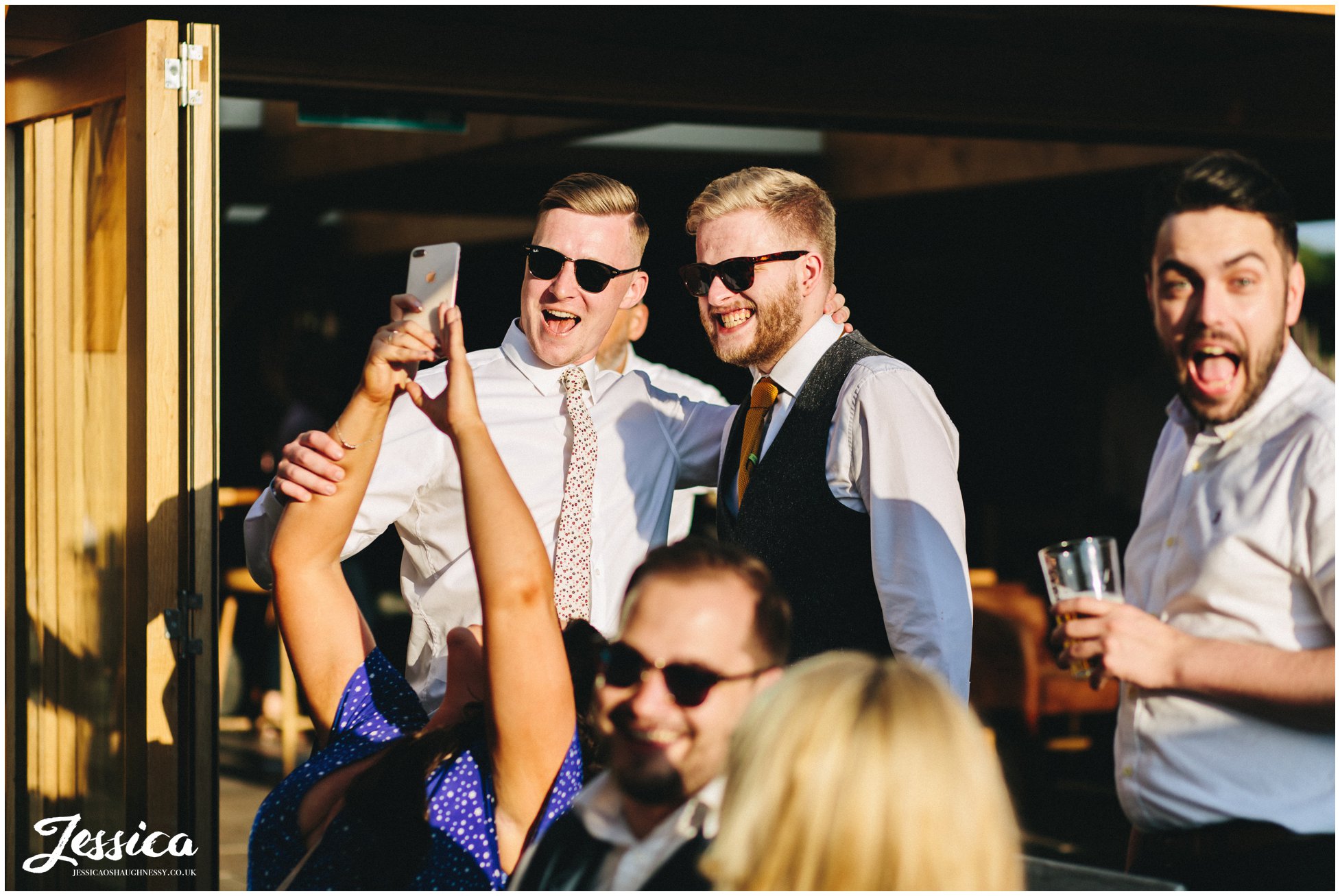 men pose for a selfie in the sun