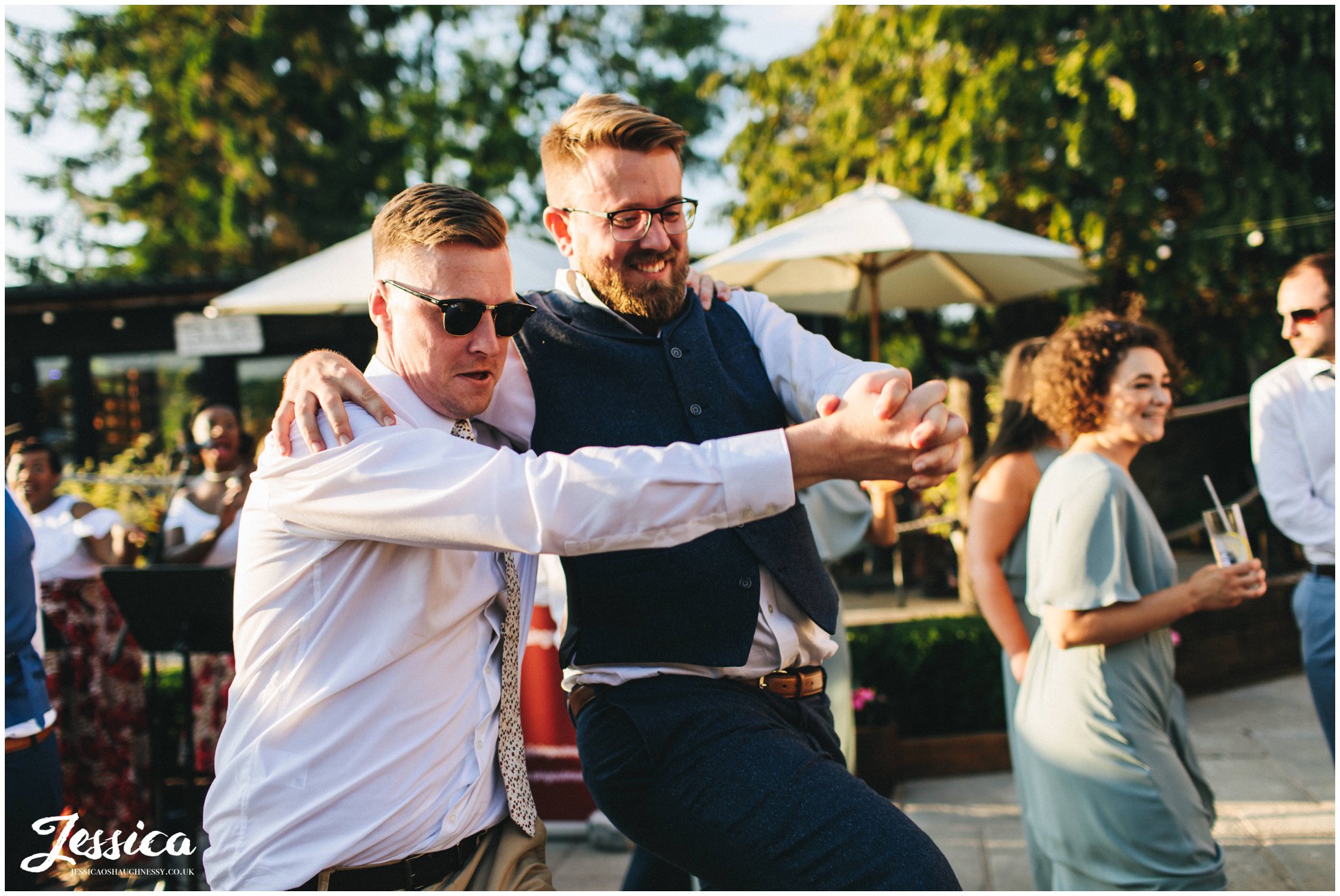 men dance together at the north wales wedding