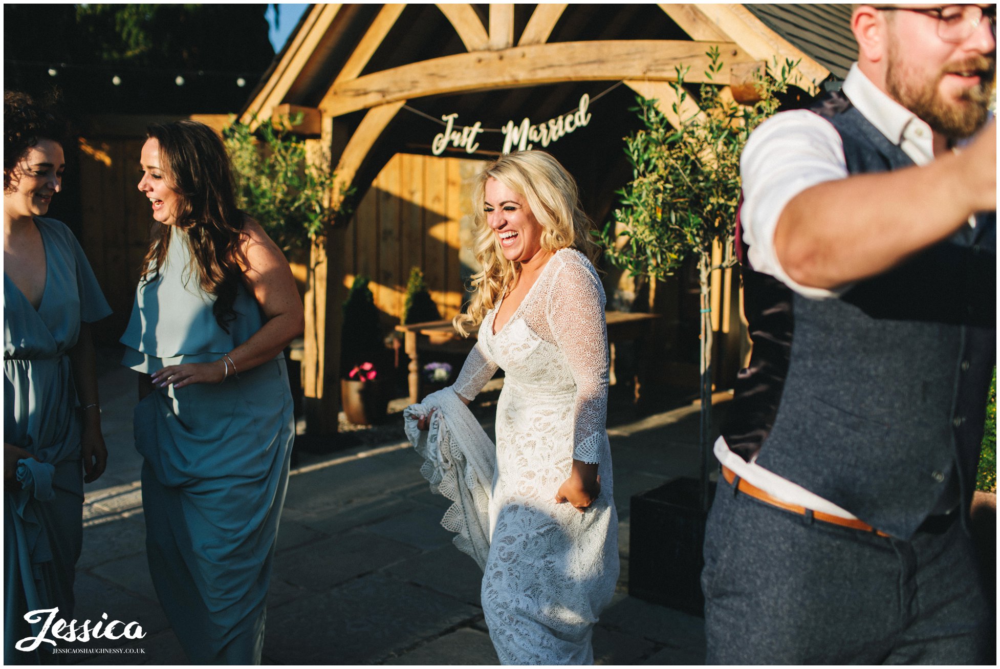 bride dances in the sun outside her north wales wedding venue