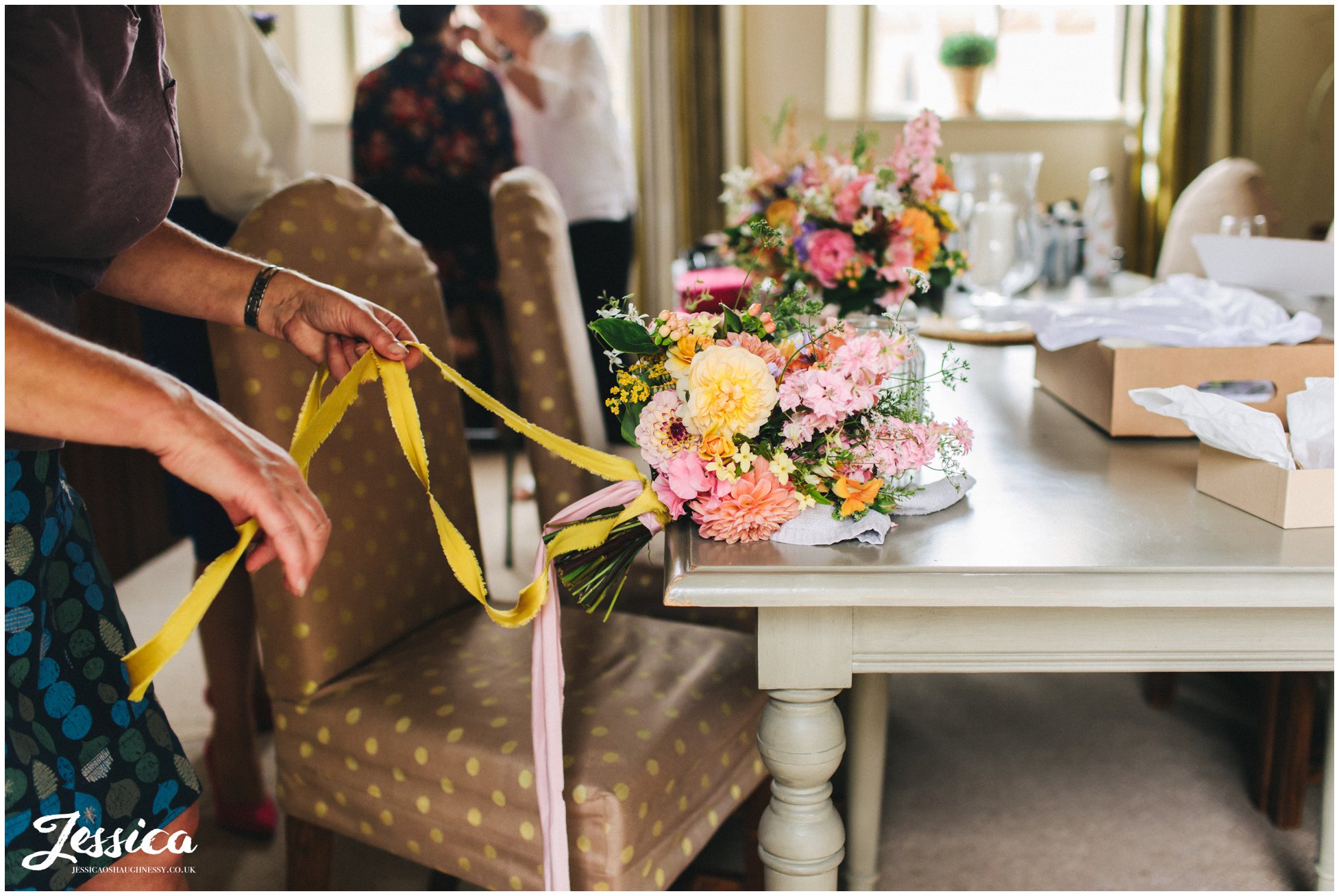 ribbons are tied to the brides bouquet