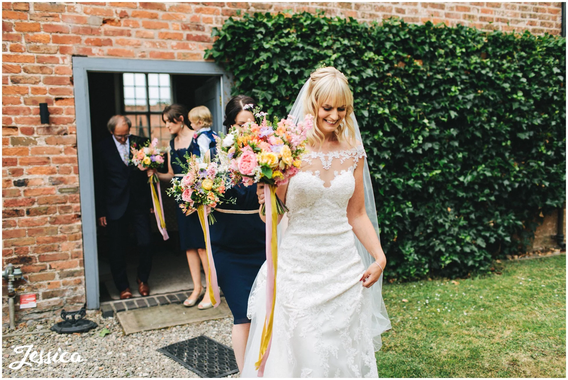 bride walks to the ceremony with her bridesmaids