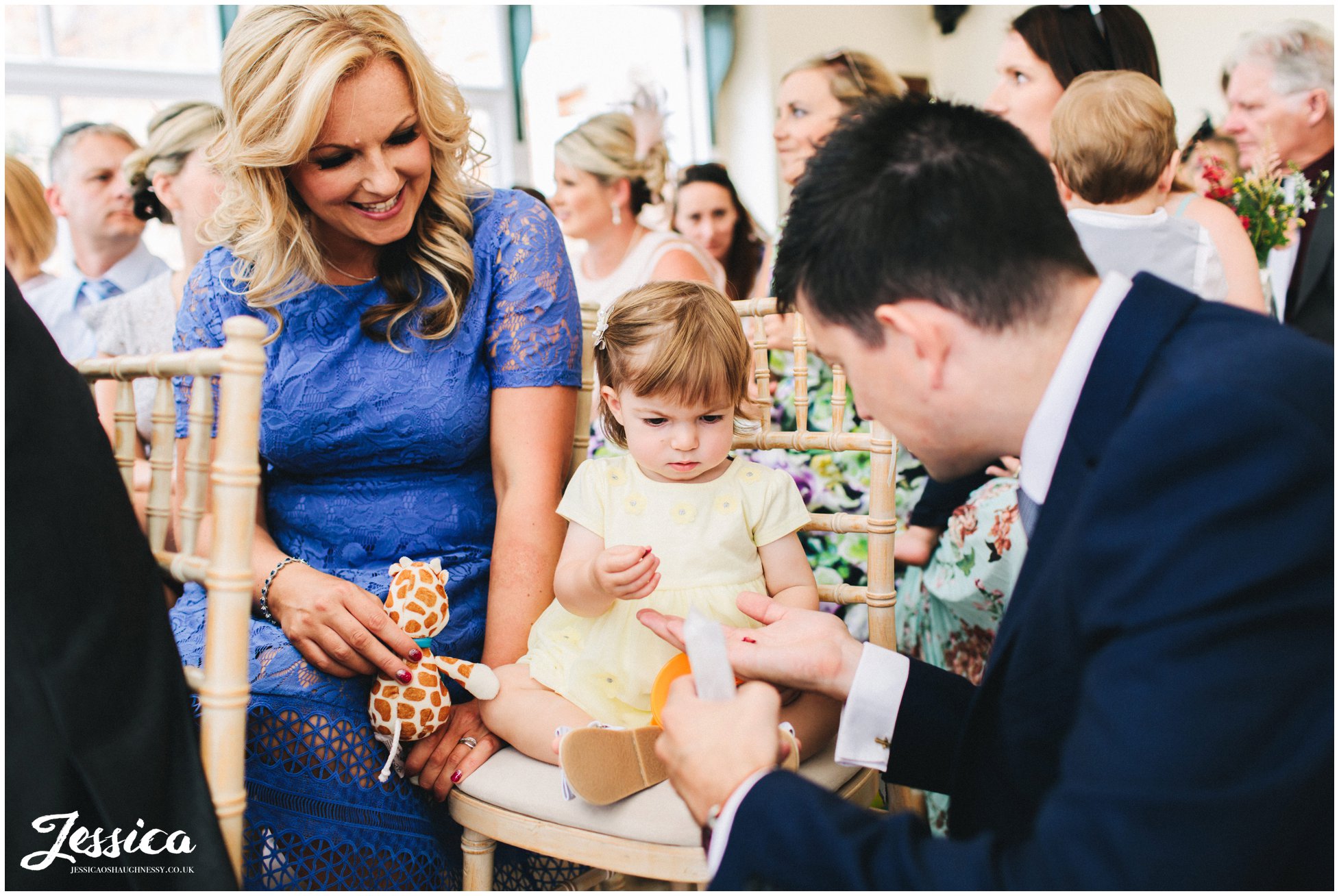 child takes hold of the confetti at the cheshire wedding