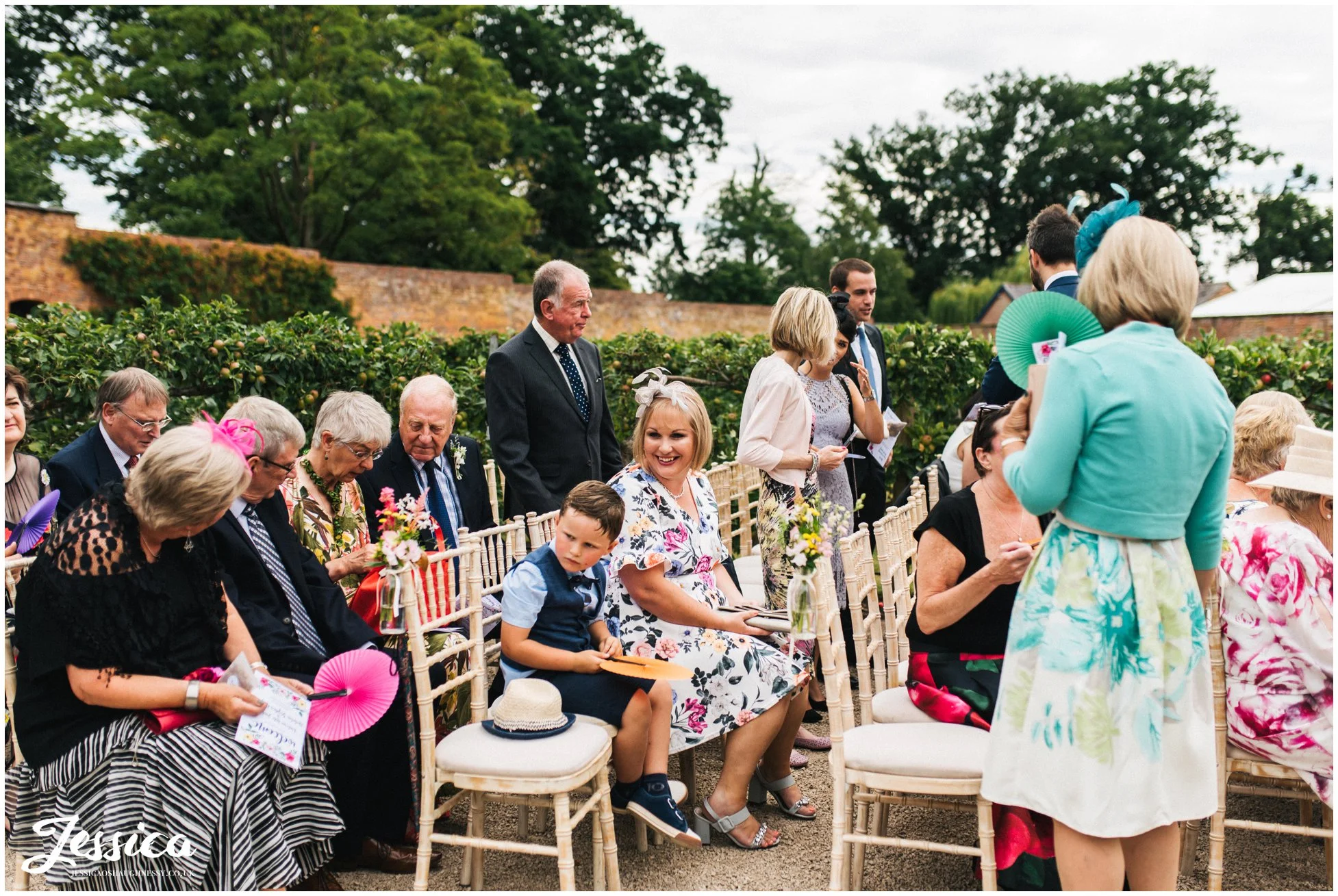 guests are seated at the ceremony at combermere abbey