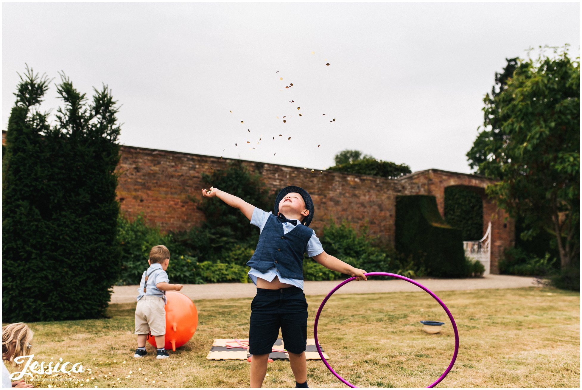 child throws confetti in the air