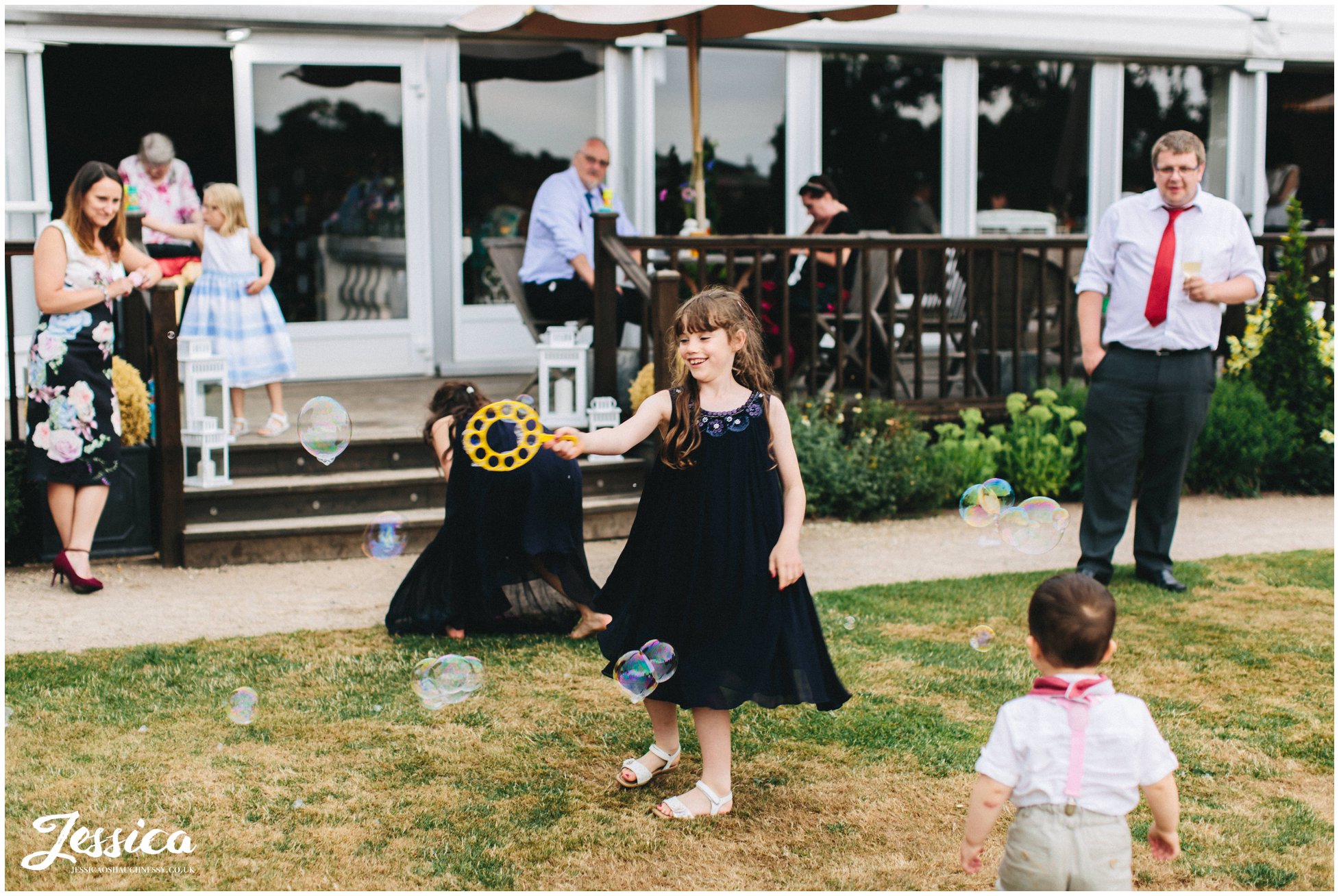 children play blowing bubbles at the cheshire wedding