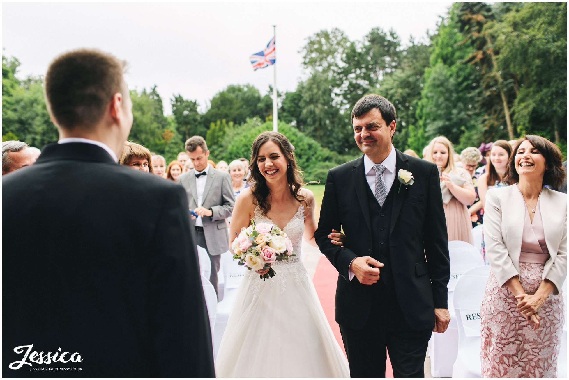 bride smiles as she see's her groom at inglewood manor in cheshire