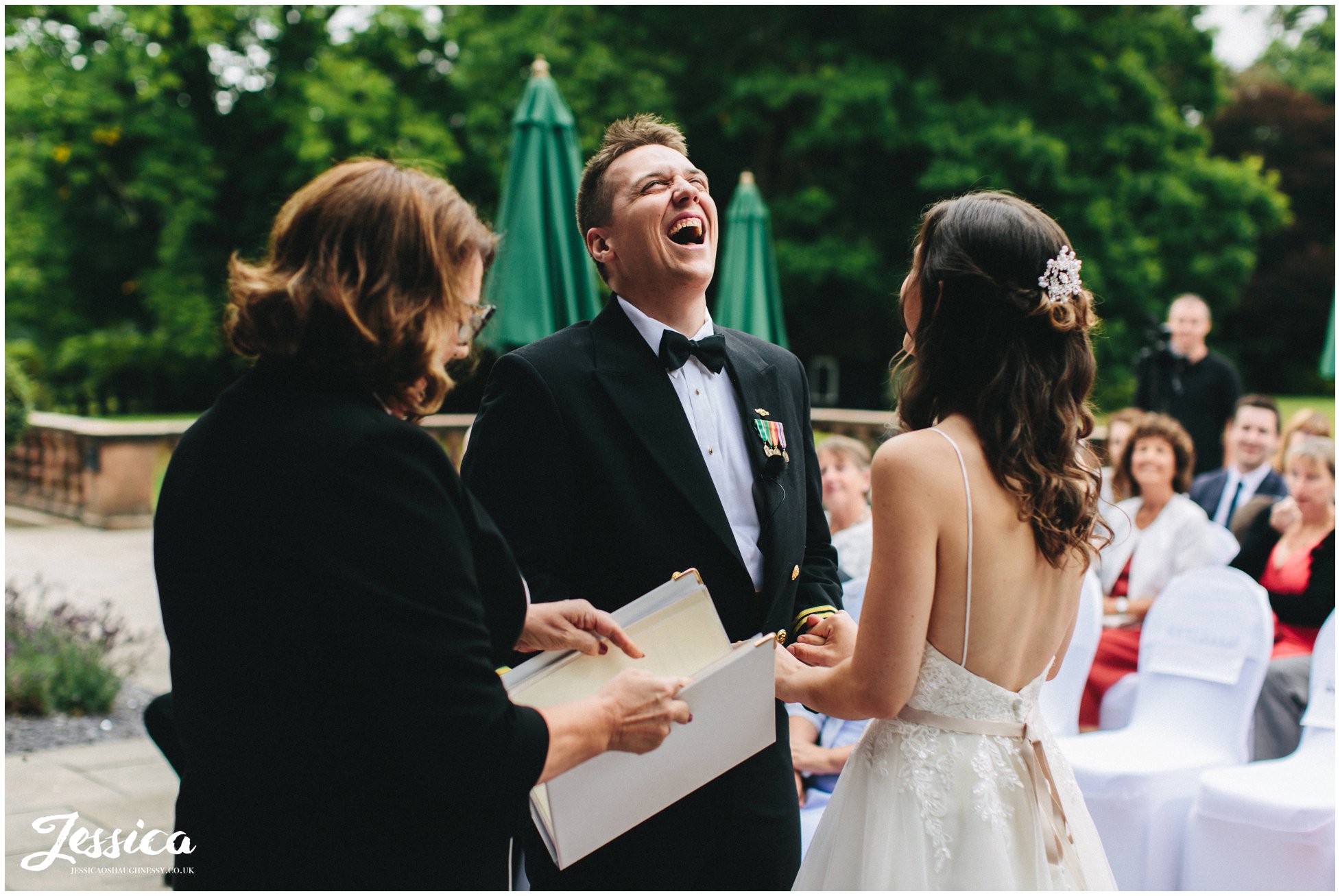 the groom laughs during the ceremony 