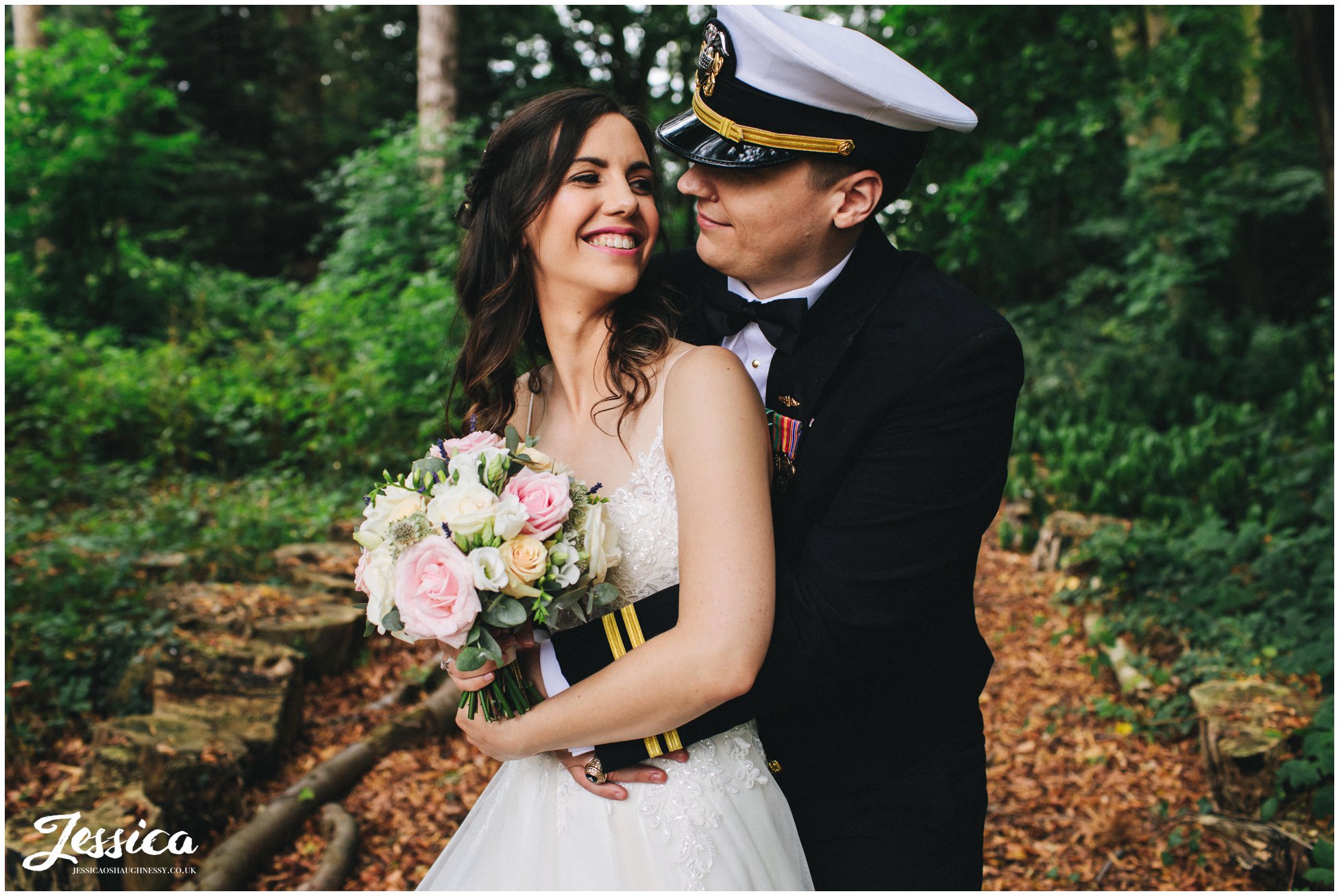 the new couple hug under the trees at inglewood manor