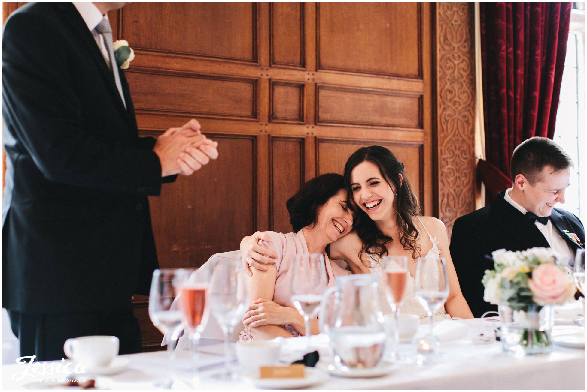 bride hugs her mother during father of the brides speech